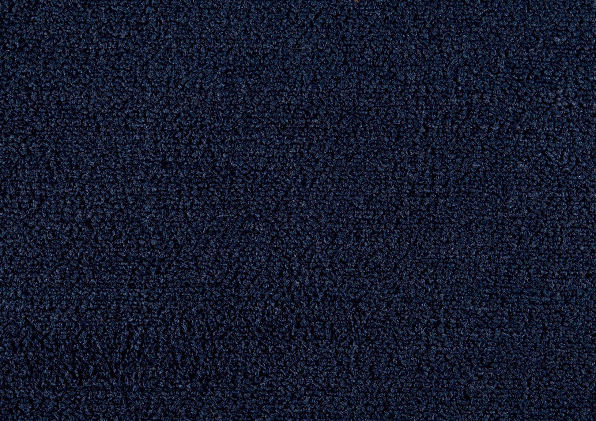 Textured navy blue fleece fabric showing soft looped fibers for cozy apparel