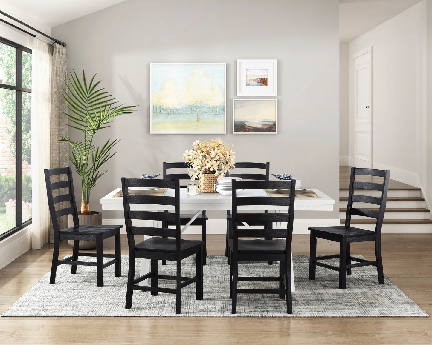 Six black ladderback dining chairs arranged around a white rectangular table