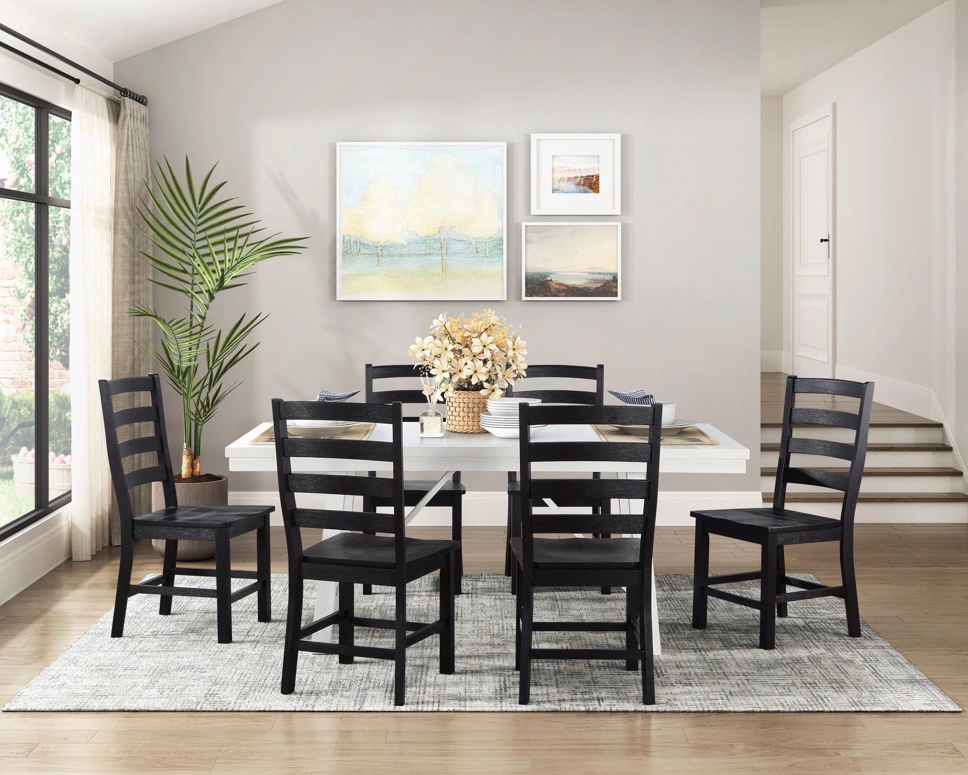 Six black ladderback dining chairs arranged around a white rectangular table