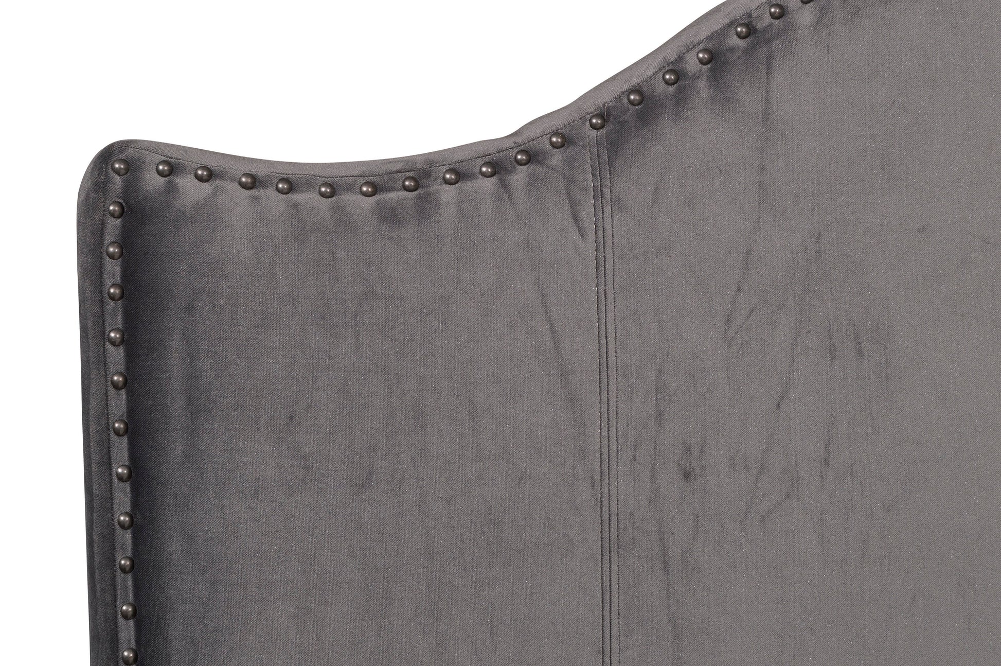 Dark gray velvet wingback headboard with pewter nailhead trim detail