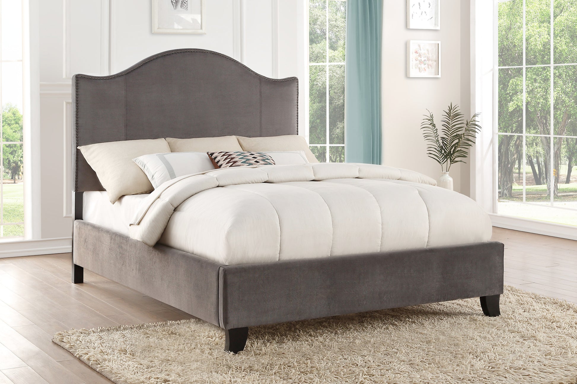 Grey velvet upholstered bed frame with tufted headboard and plush bedding