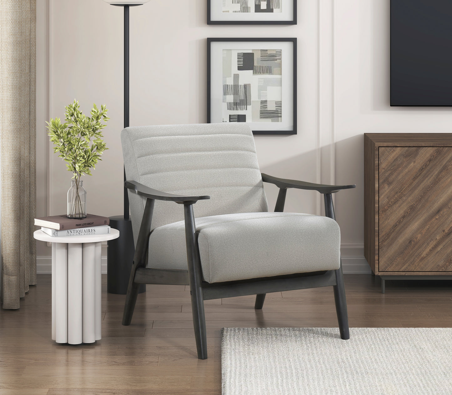 Light gray upholstered accent chair with dark wood frame ribbed back and low profile