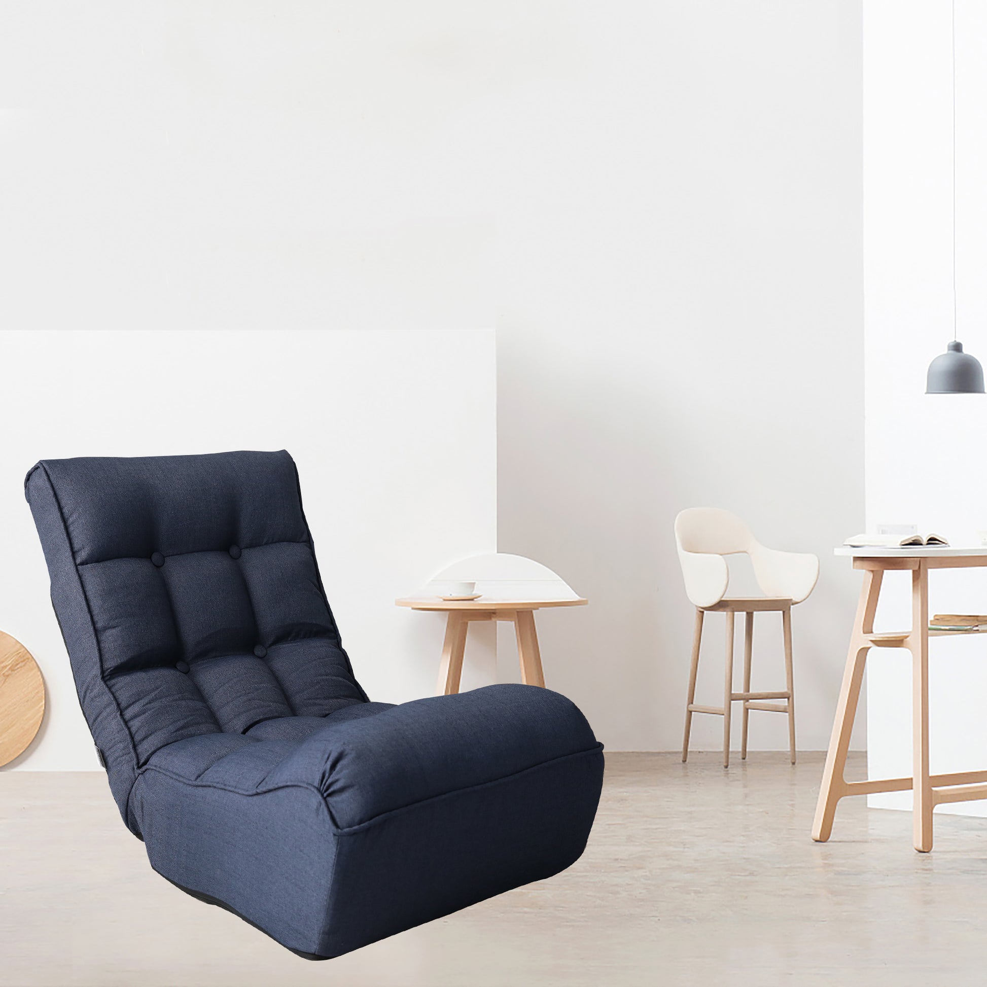 Tufted navy blue floor chair with adjustable back for comfortable lounging