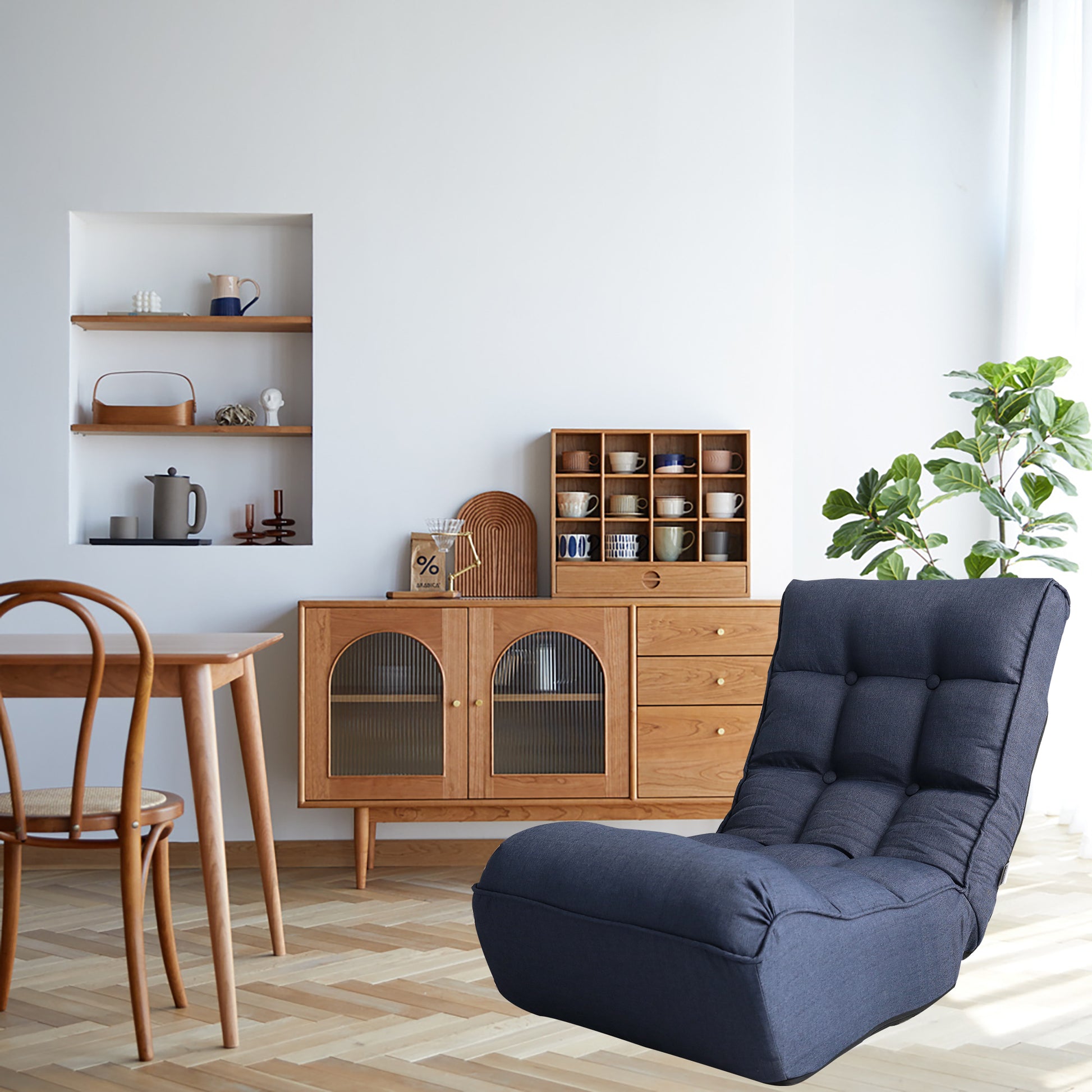 Dark blue tufted floor chair with adjustable backrest for relaxed seating