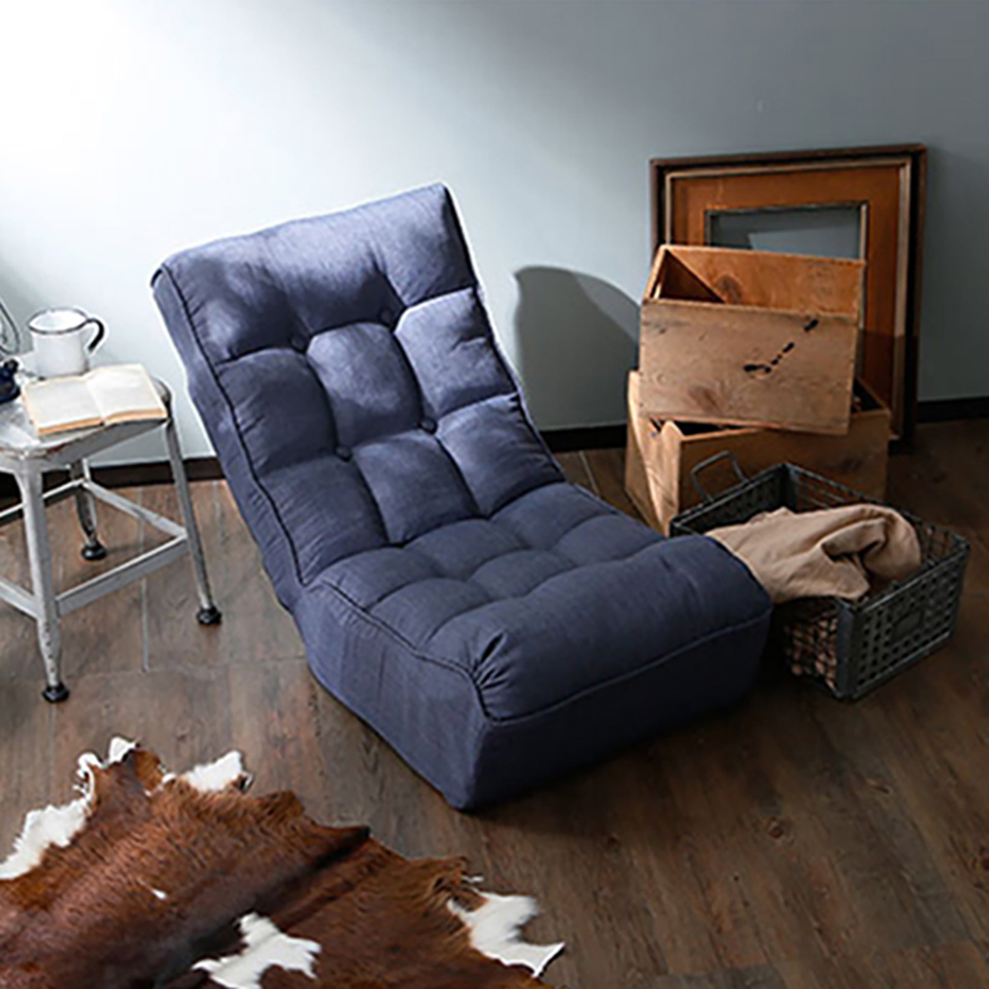 Dark blue tufted floor chair with adjustable backrest and plush cushioning