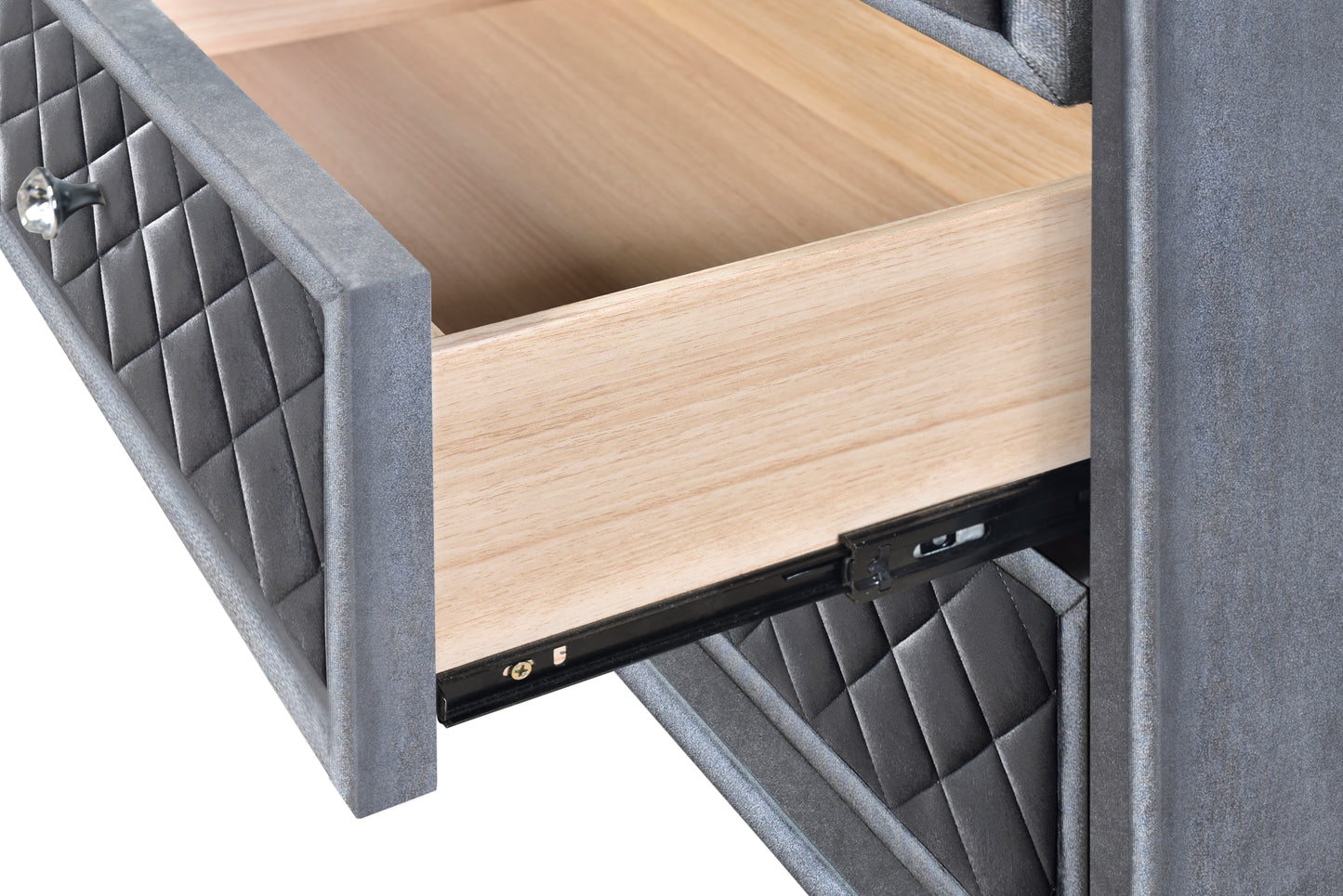 Grey upholstered drawer front with diamond tufting and crystal knob part of a glamorous dresser