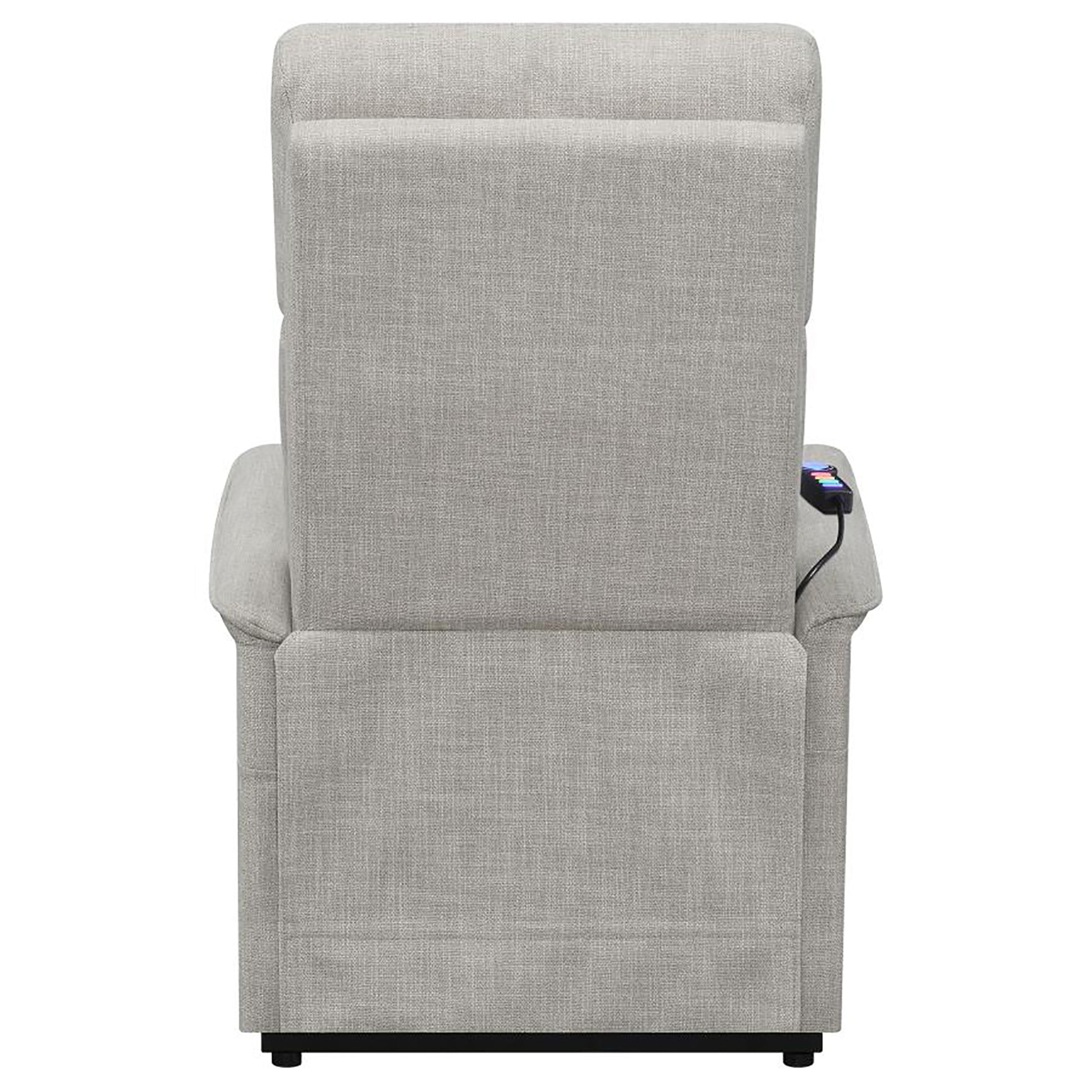 Back view of a light gray fabric power lift recliner with a remote control attached