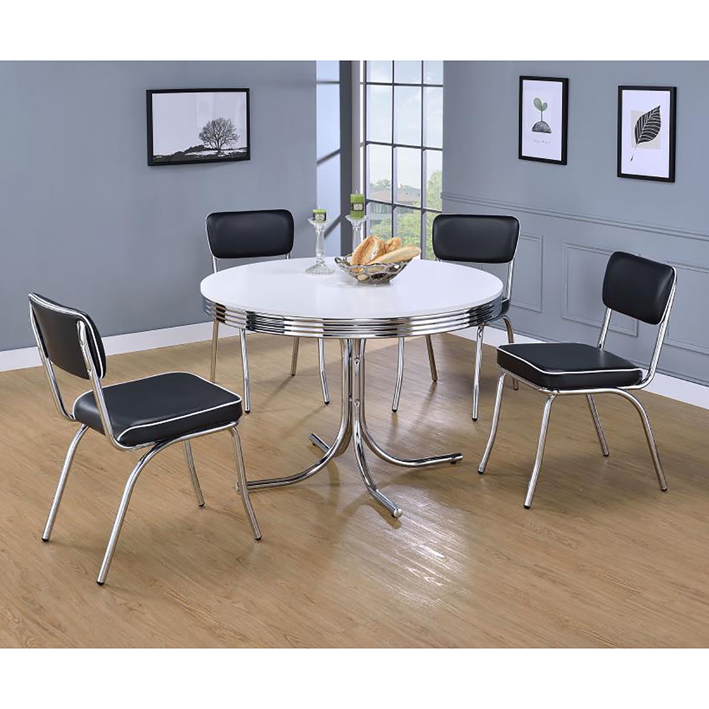 Retro white diner table with chrome trim and four black vinyl chairs