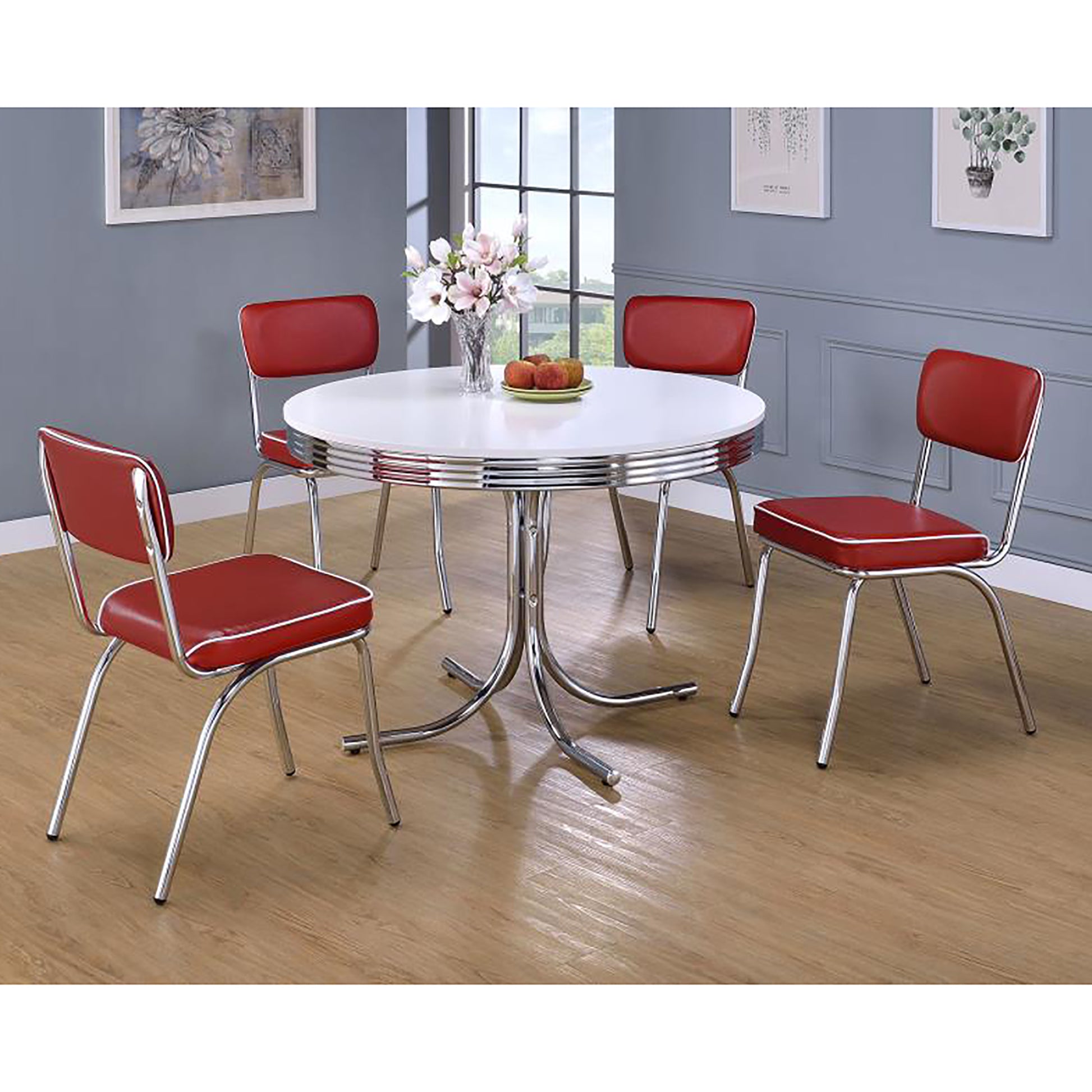 Retro red vinyl diner chairs with chrome legs and white trim around a white tabletop table