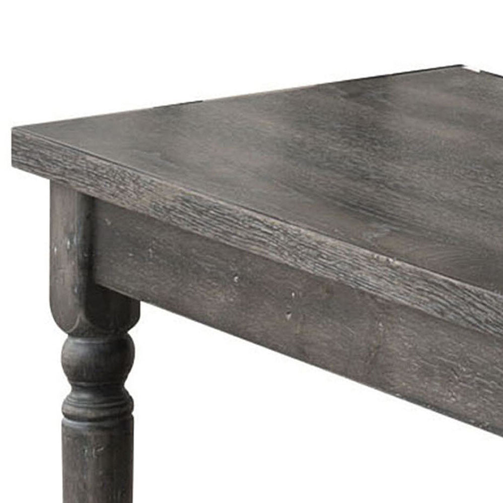 Farmhouse style gray wood dining table detail with turned leg