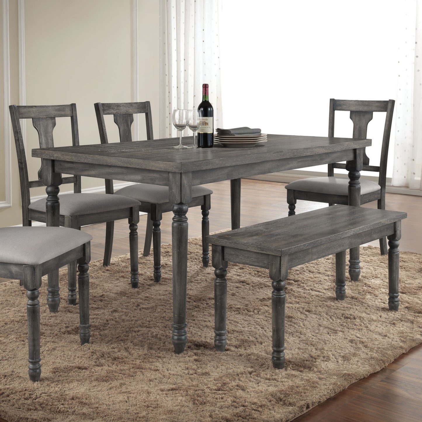 Rustic gray wood dining table with upholstered chairs and bench seating