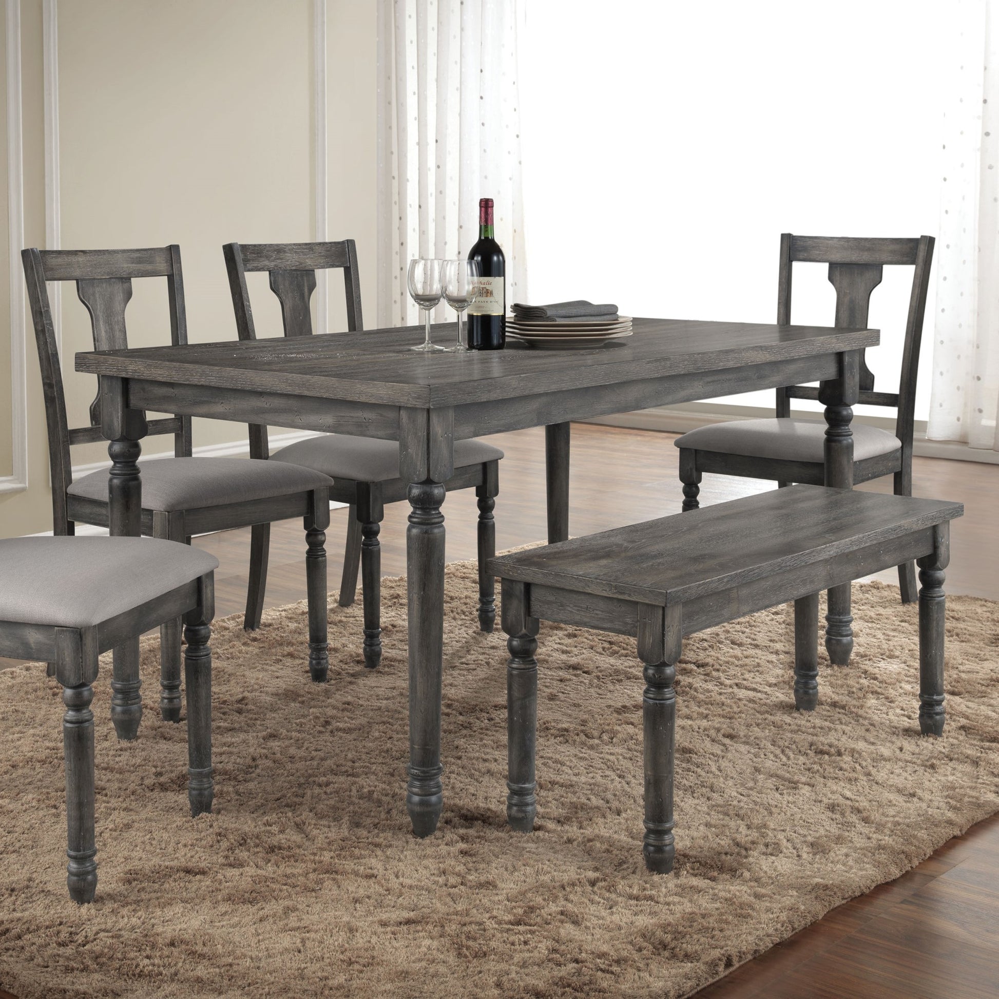 Rustic gray wood dining table with upholstered chairs and bench seating