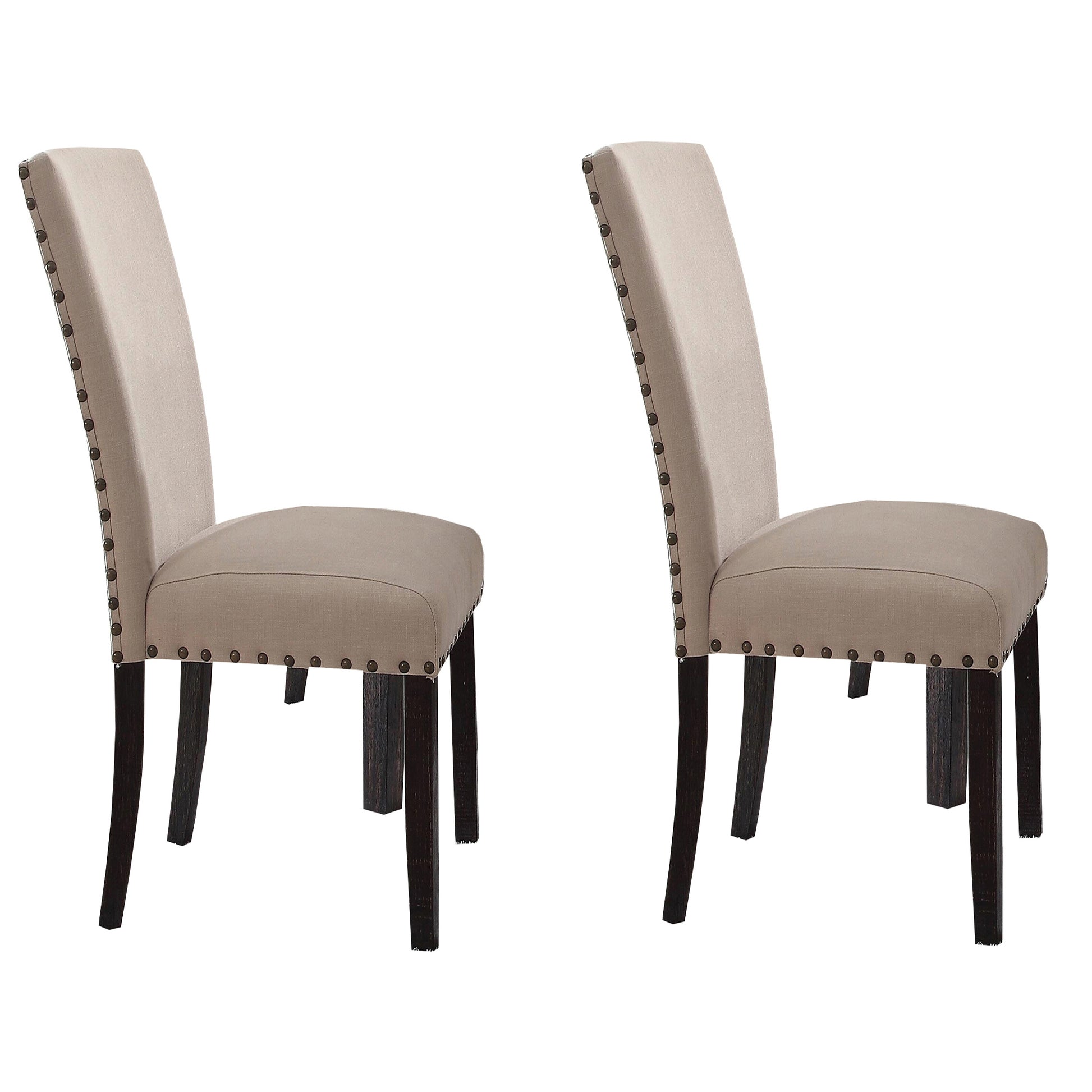 Two beige upholstered dining chairs with dark wood legs and nailhead trim