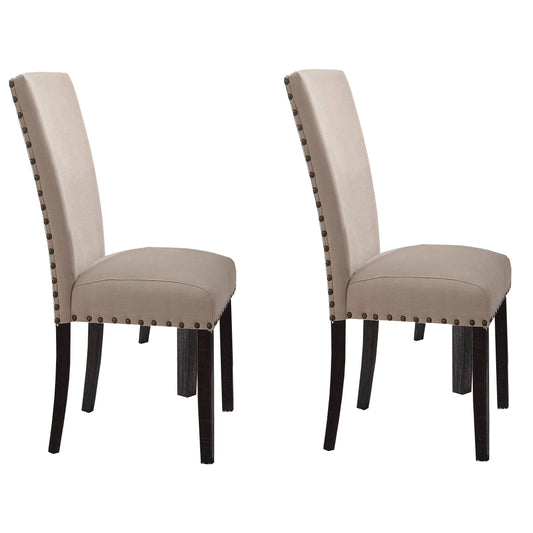 Two beige upholstered dining chairs with dark wood legs and nailhead trim
