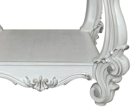 White ornate upholstered bench with carved wood detailing for a vanity table