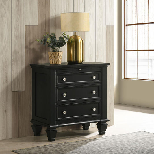 Black wooden nightstand with three drawers and silver knobs perfect for bedroom storage
