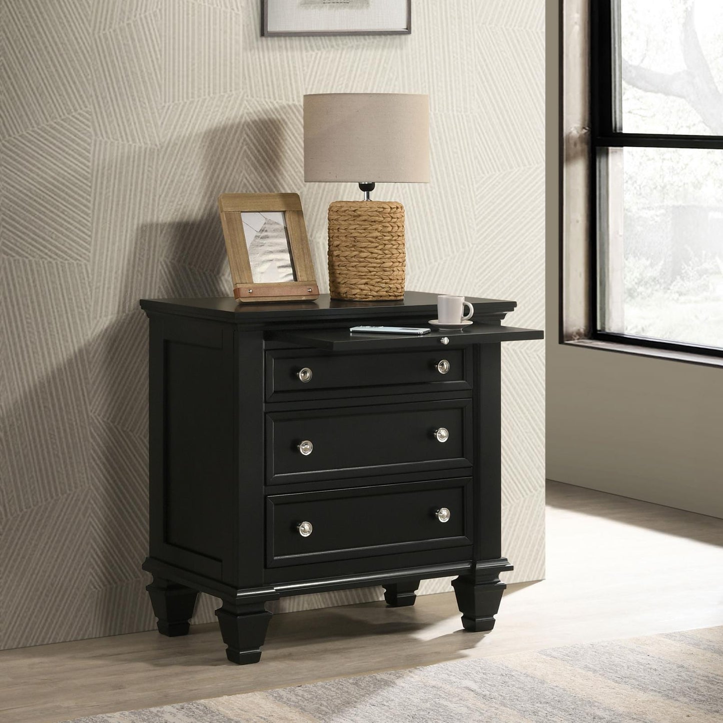Black bedside table with three drawers and crystal knobs featuring a pullout tray