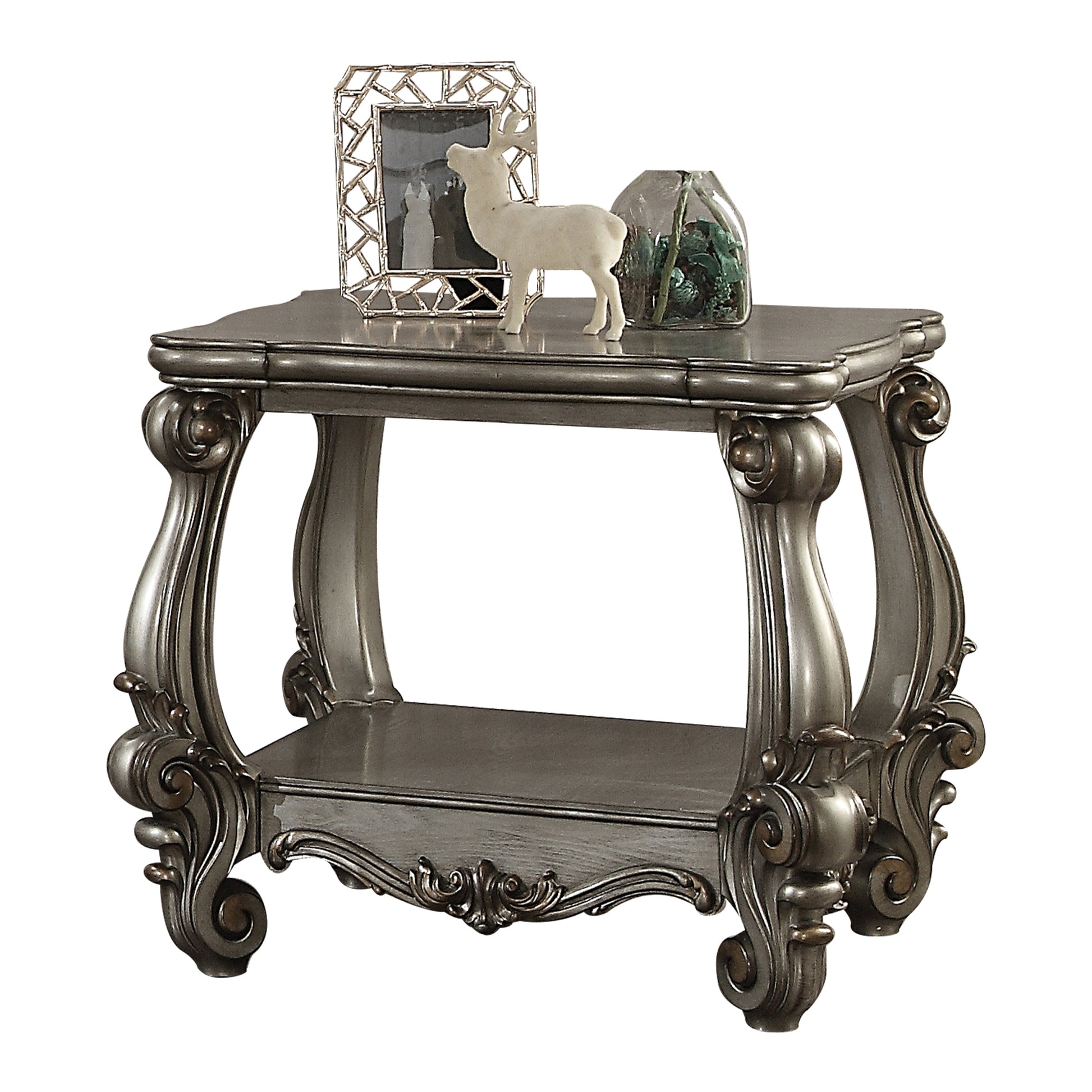 Ornate carved gray end table with lower shelf and decorative accents