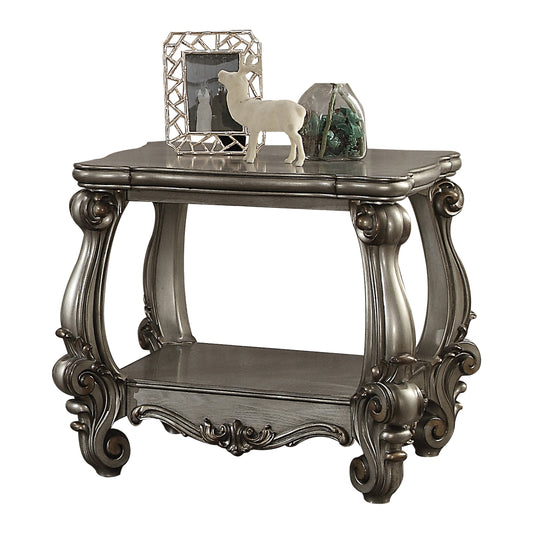 Ornate carved gray end table with lower shelf and decorative accents
