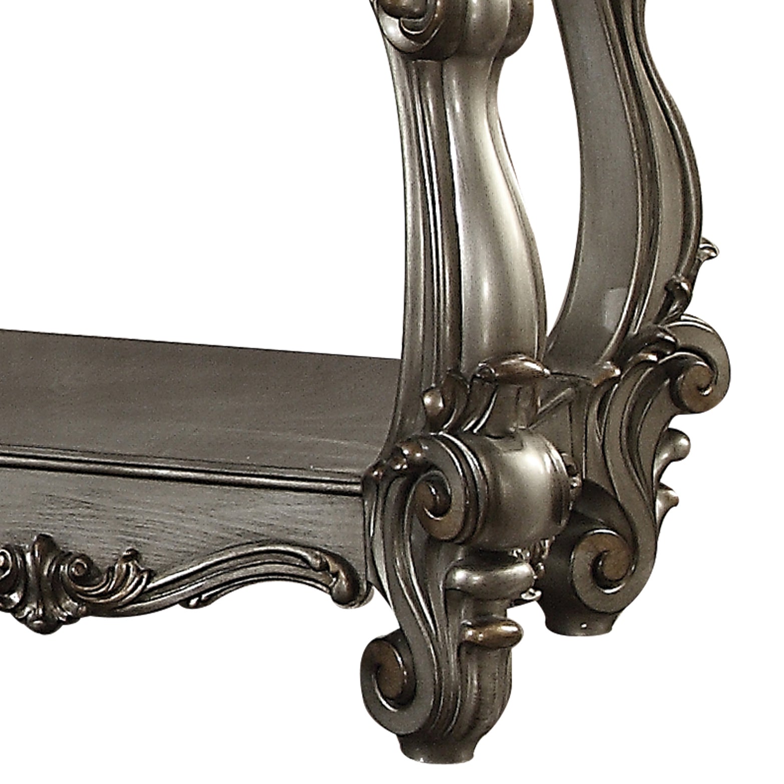 Ornate carved pedestal detail on a dark grey antique table leg with gold accents