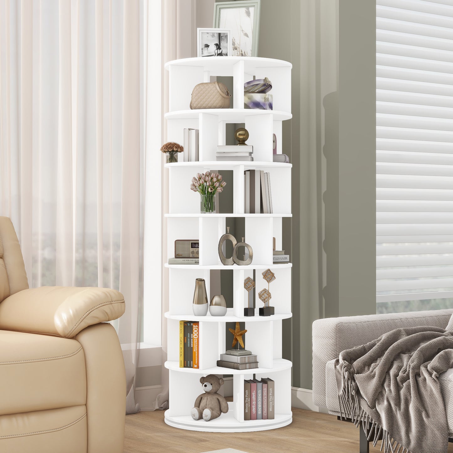 White rotating bookshelf with  tiers displaying books vases and decor
