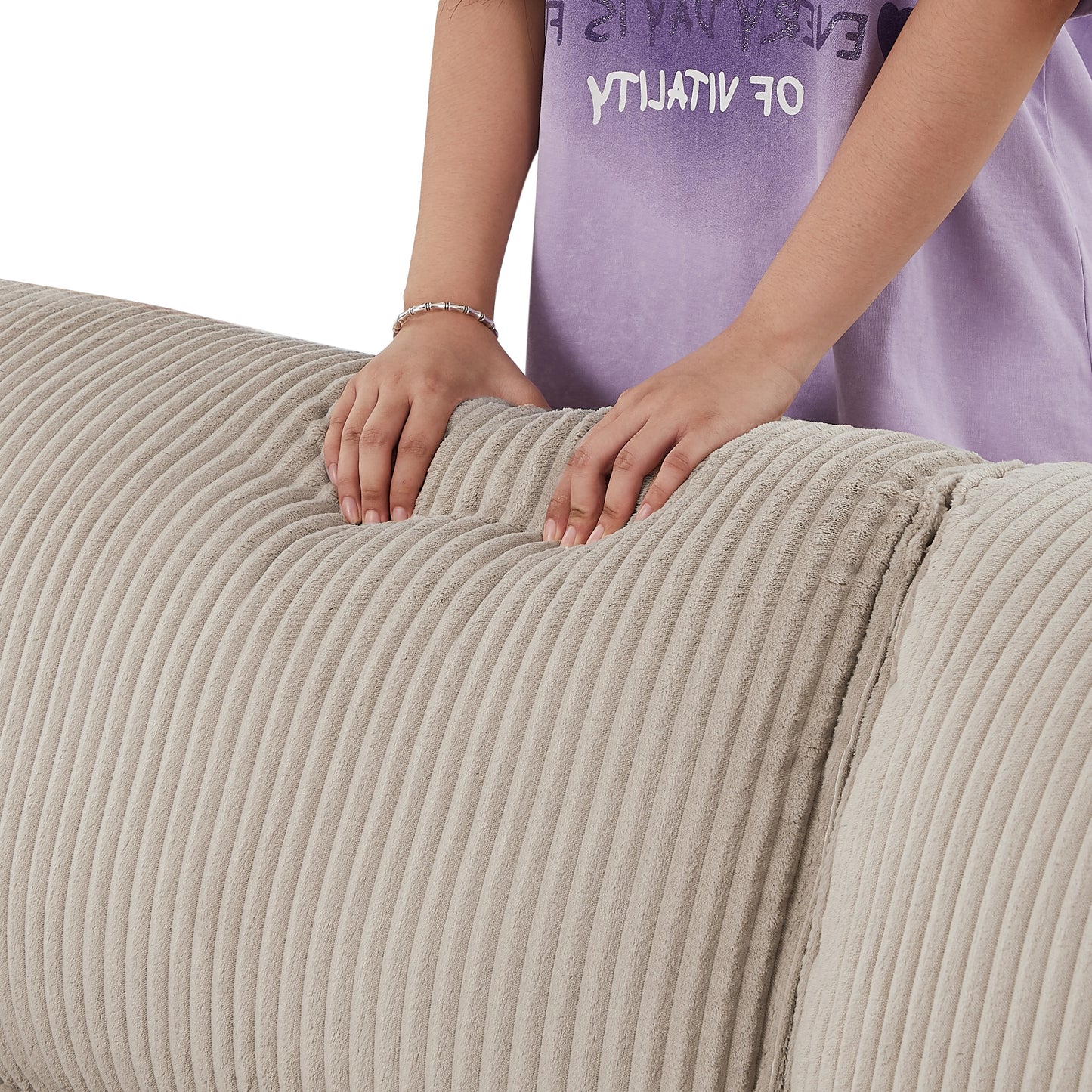 Close up of hands touching soft beige corduroy sofa upholstery for a cozy feel