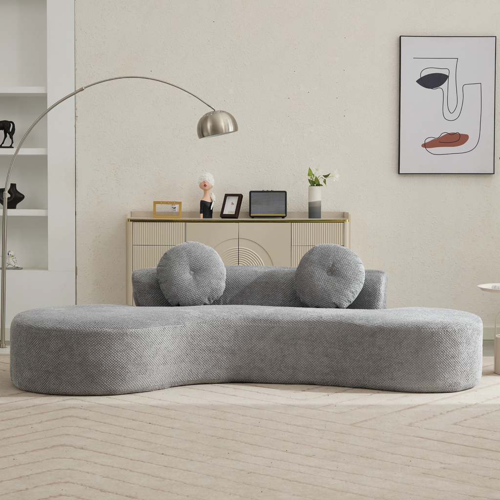 Curved grey fabric sofa with circular accent pillows modern design for living spaces