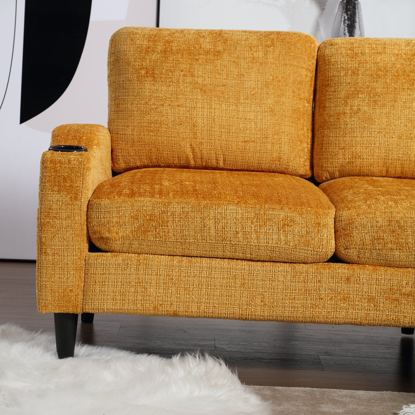 Textured yellow couch with a builtin cup holder on the armrest