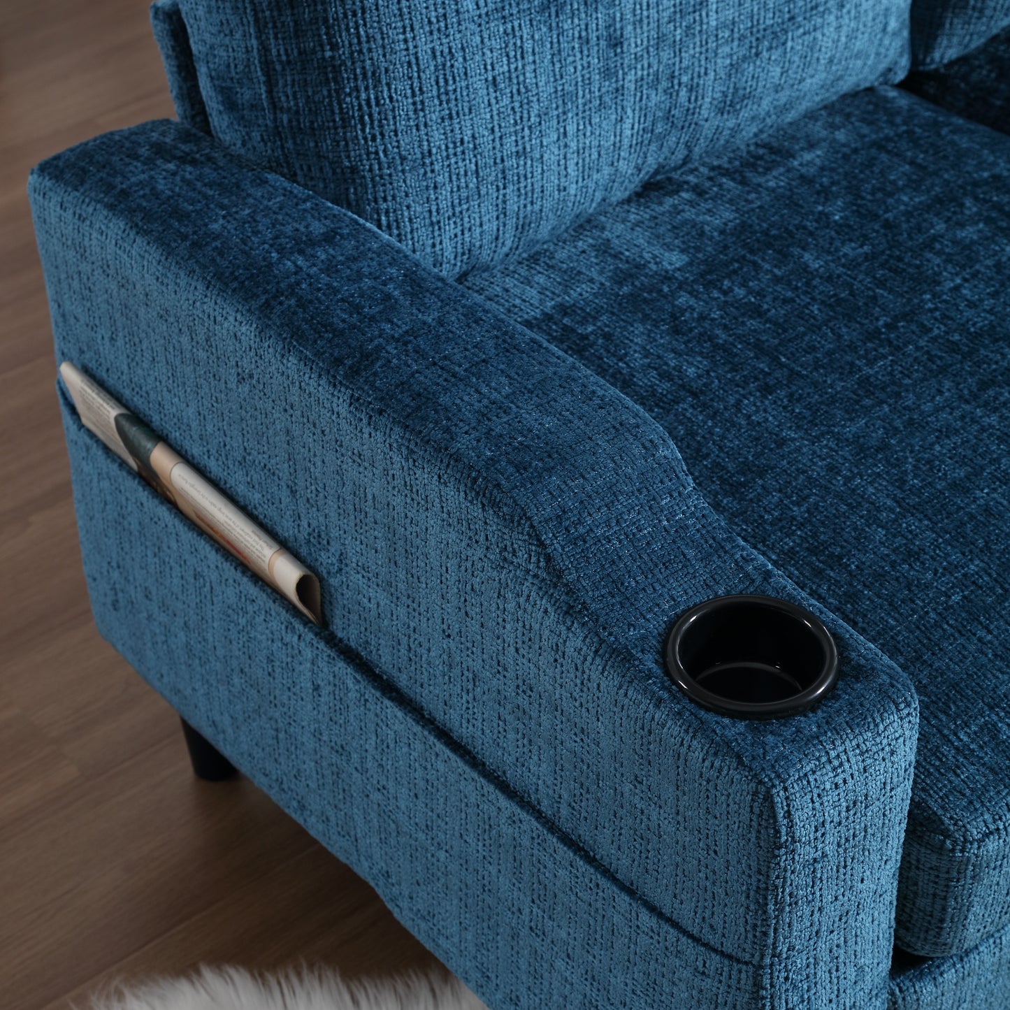 Blue fabric armchair with integrated magazine holder and cup holder
