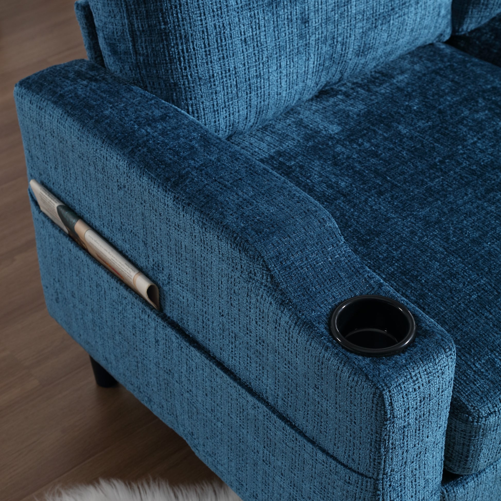 Blue fabric armchair with integrated magazine holder and cup holder