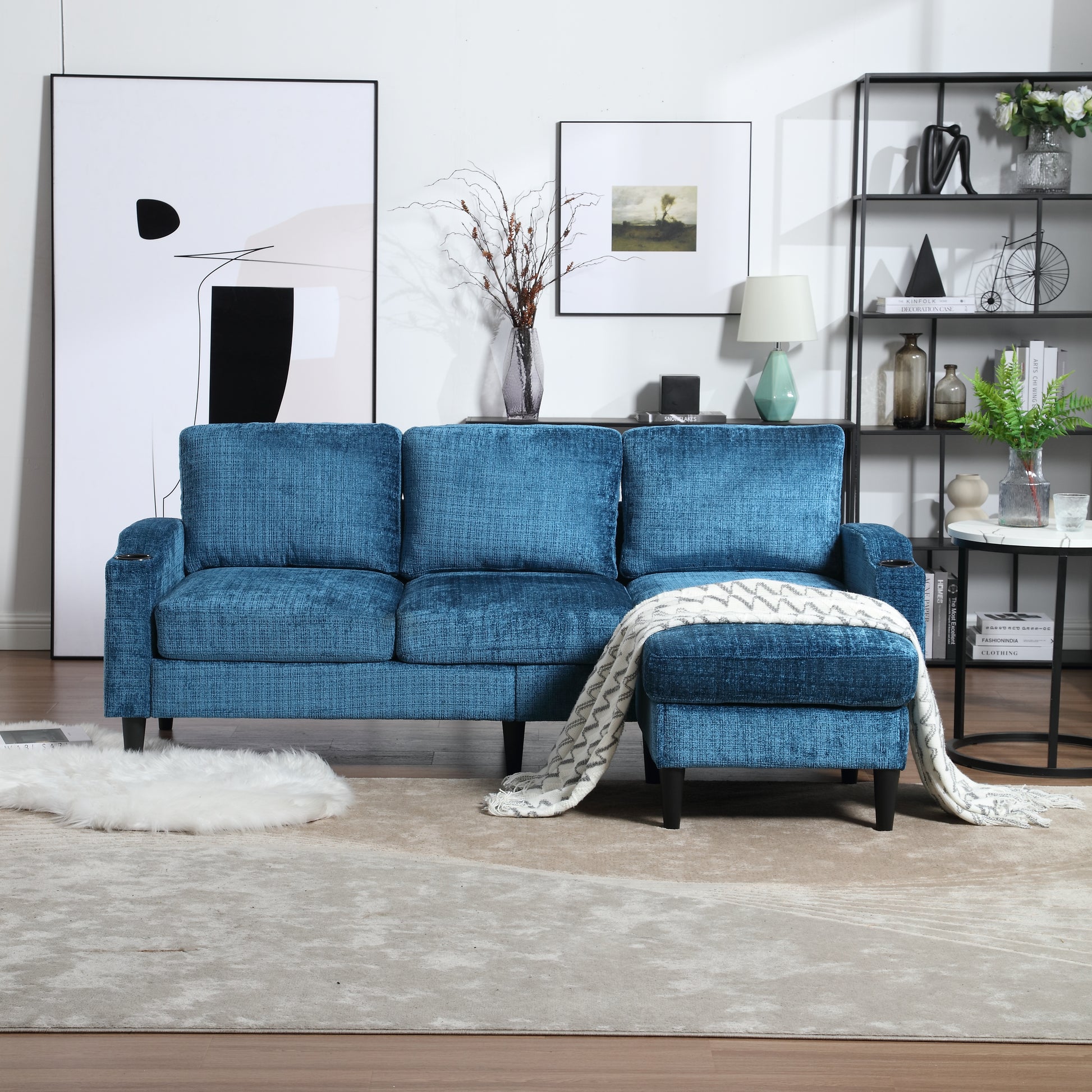 Teal upholstered sectional sofa with plush fabric and a throw blanket