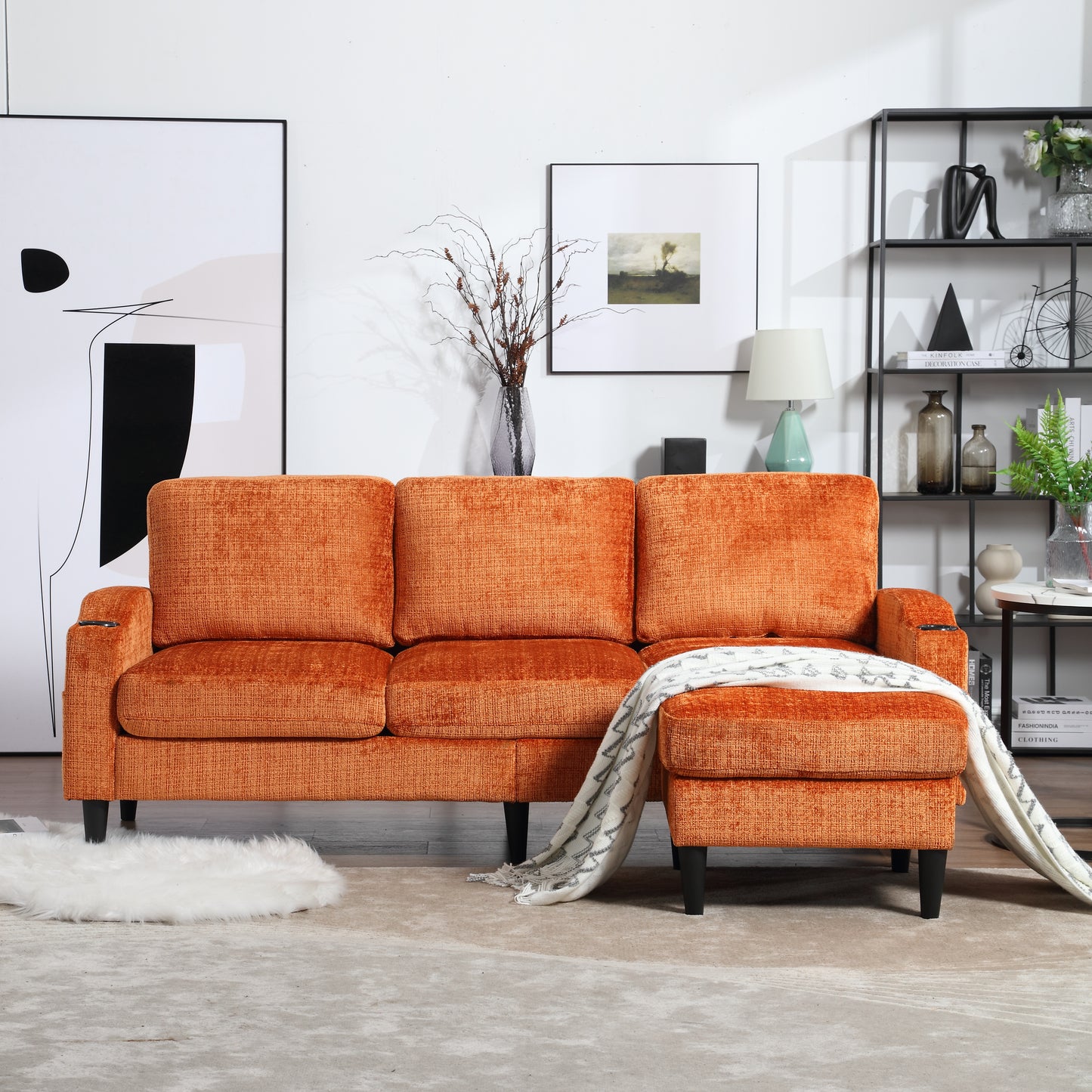 Orange textured fabric sectional sofa with ottoman and blanket draped over it