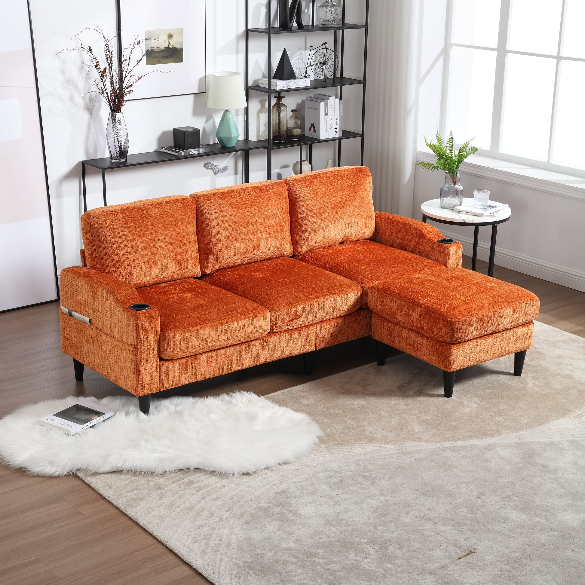 Plush orange sectional sofa with chaise featuring builtin cup holders for ultimate relaxation