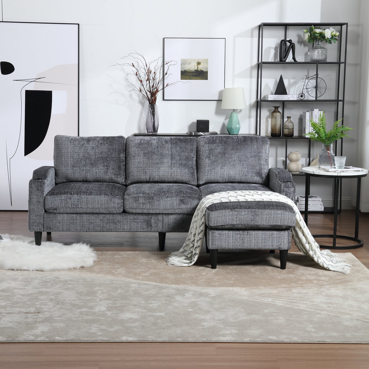 Dark gray textured fabric sectional sofa with chaise lounge and decorative throw