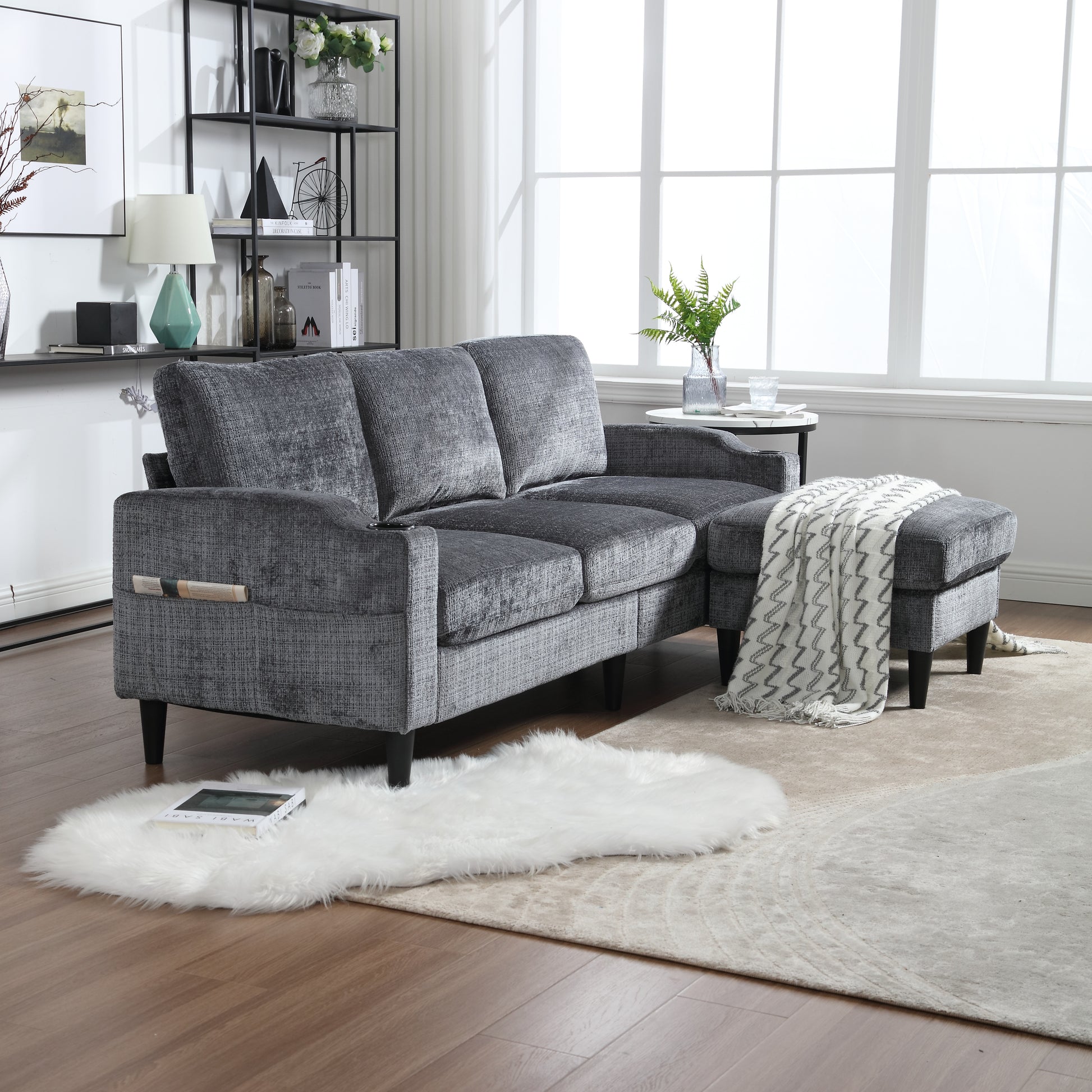 Dark grey upholstered sectional sofa with chaise and matching ottoman ideal for living rooms