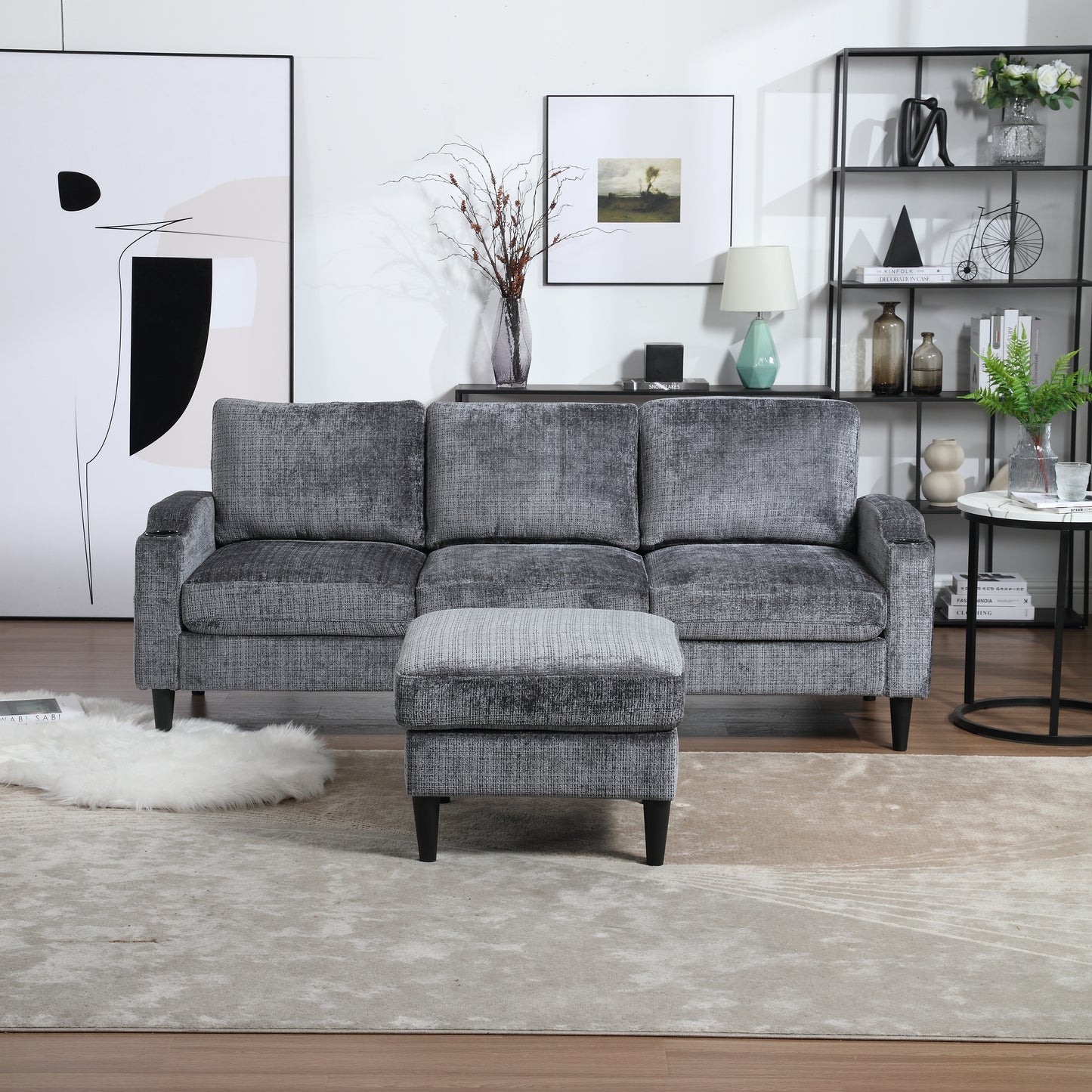 Gray upholstered sofa and matching ottoman in a modern living room setting