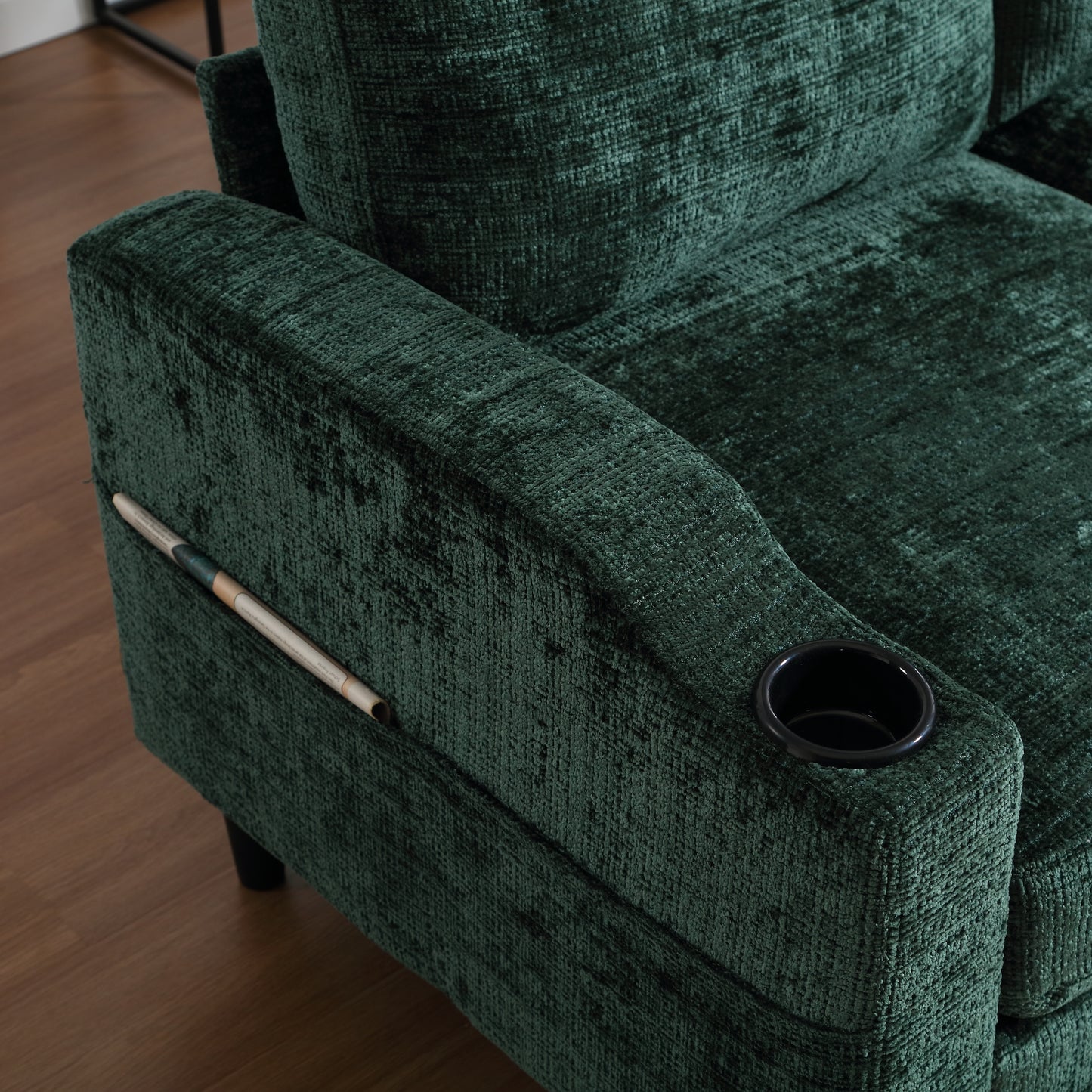 Closeup of a textured forest green recliner armrest with integrated cup holder and storage pocket