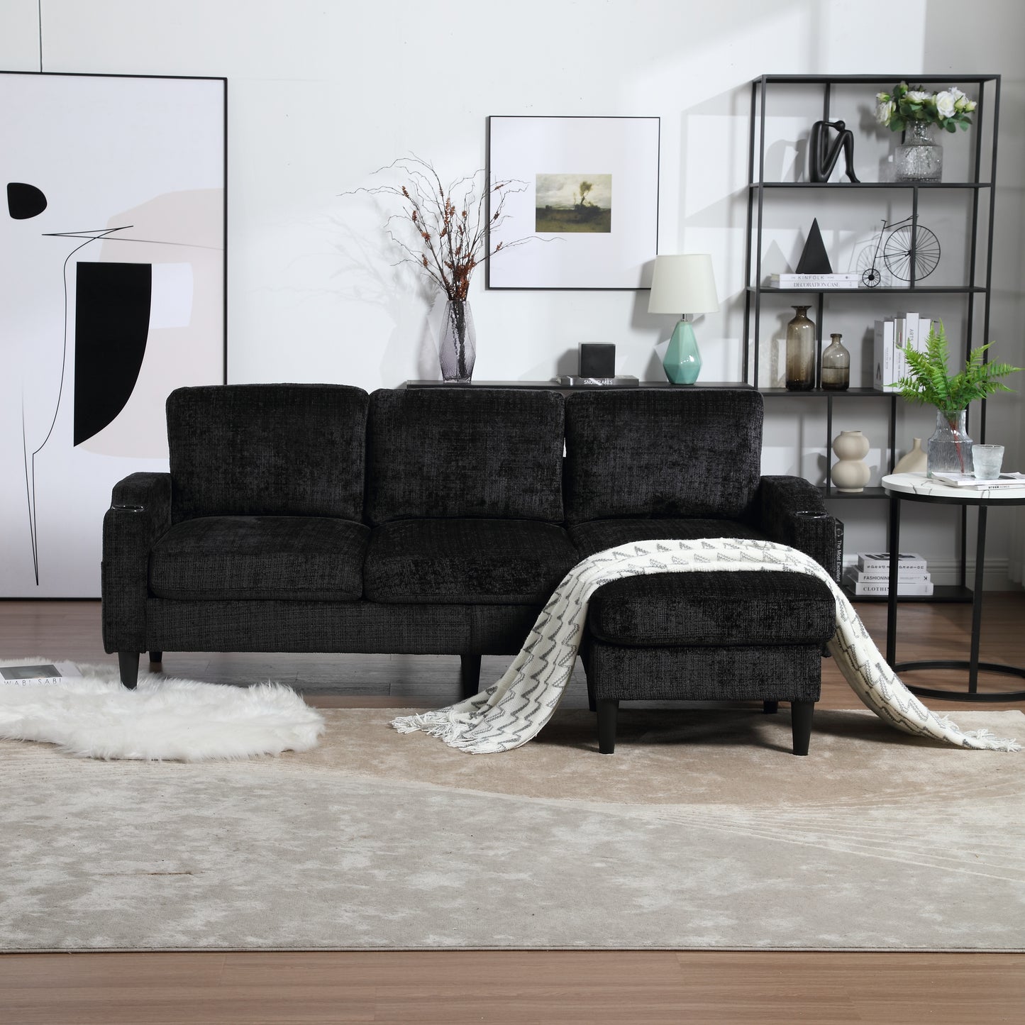 Luxurious dark charcoal textured fabric sofa with attached ottoman and cozy throw blanket