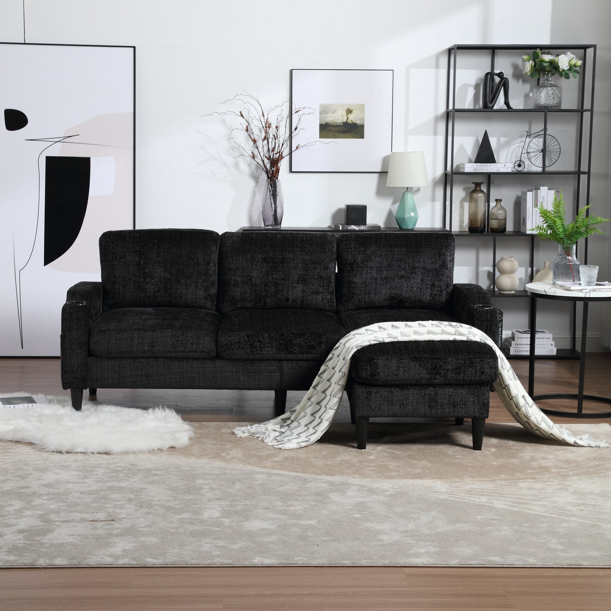 Luxurious dark charcoal textured fabric sofa with attached ottoman and cozy throw blanket