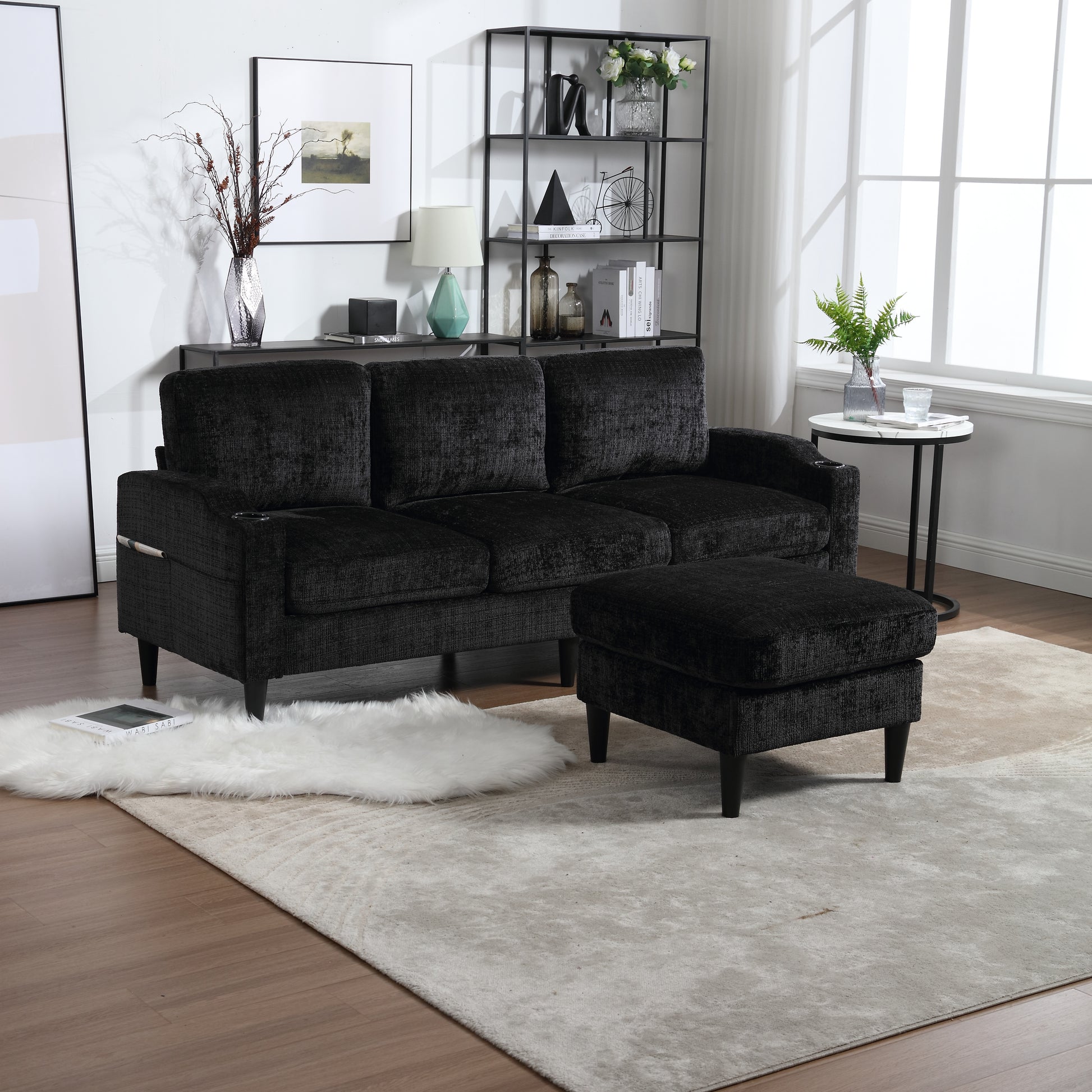 Plush black threeseater sofa with matching ottoman and cup holder