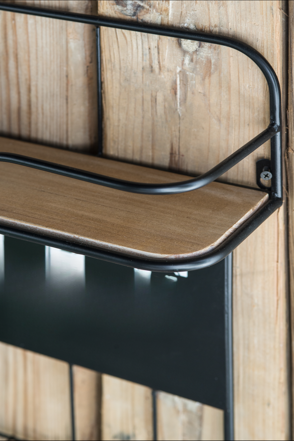 Rustic wood and black metal wall shelf with a curved frame