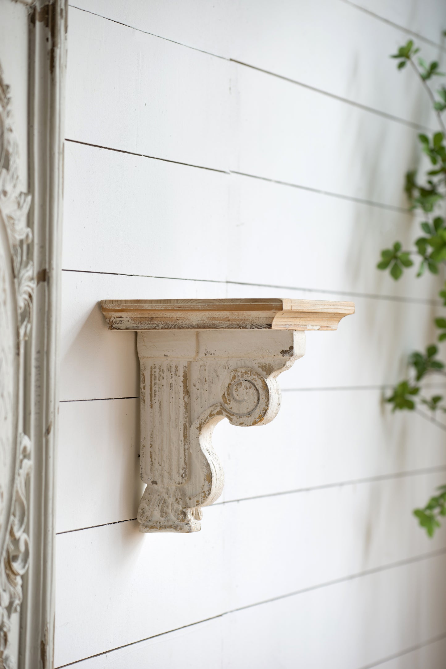 Distressed white ornate wall bracket with natural wood shelf