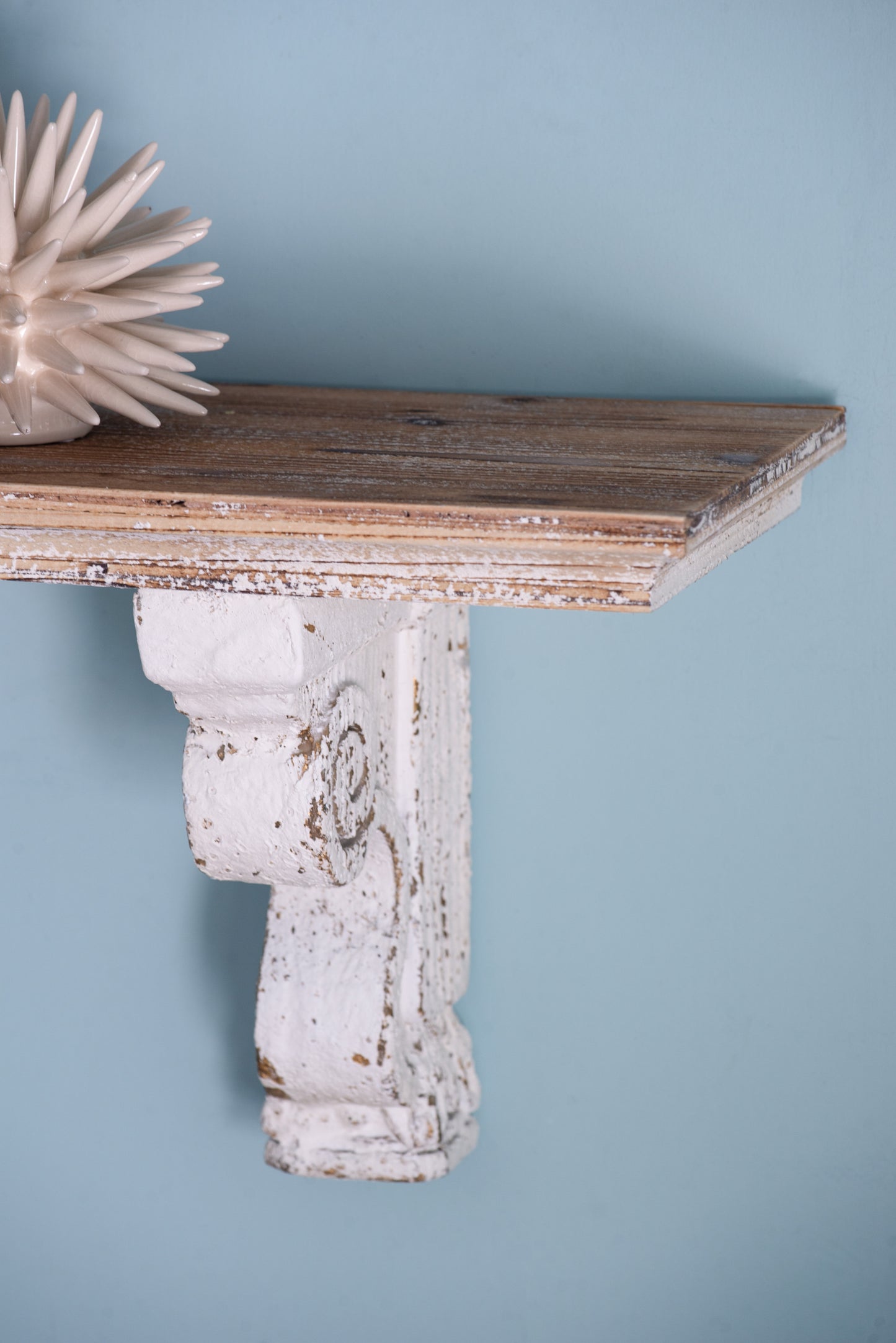 Distressed white ornate corbel shelf bracket with distressed wood plank top