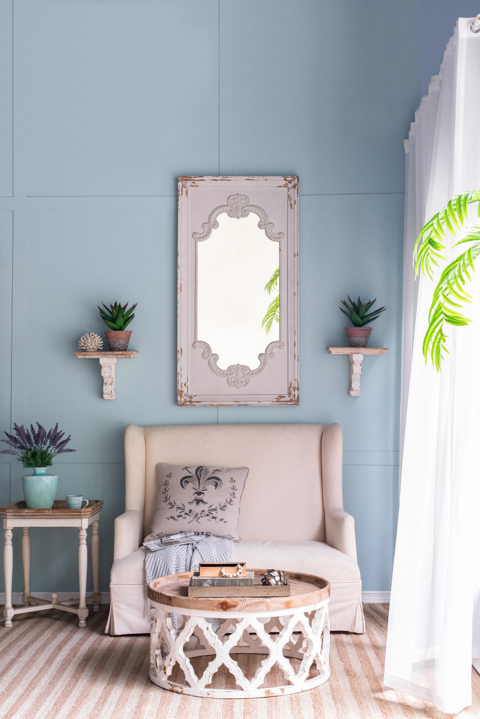 Vintage ornate decorative mirror with distressed white frame ideal for French country decor