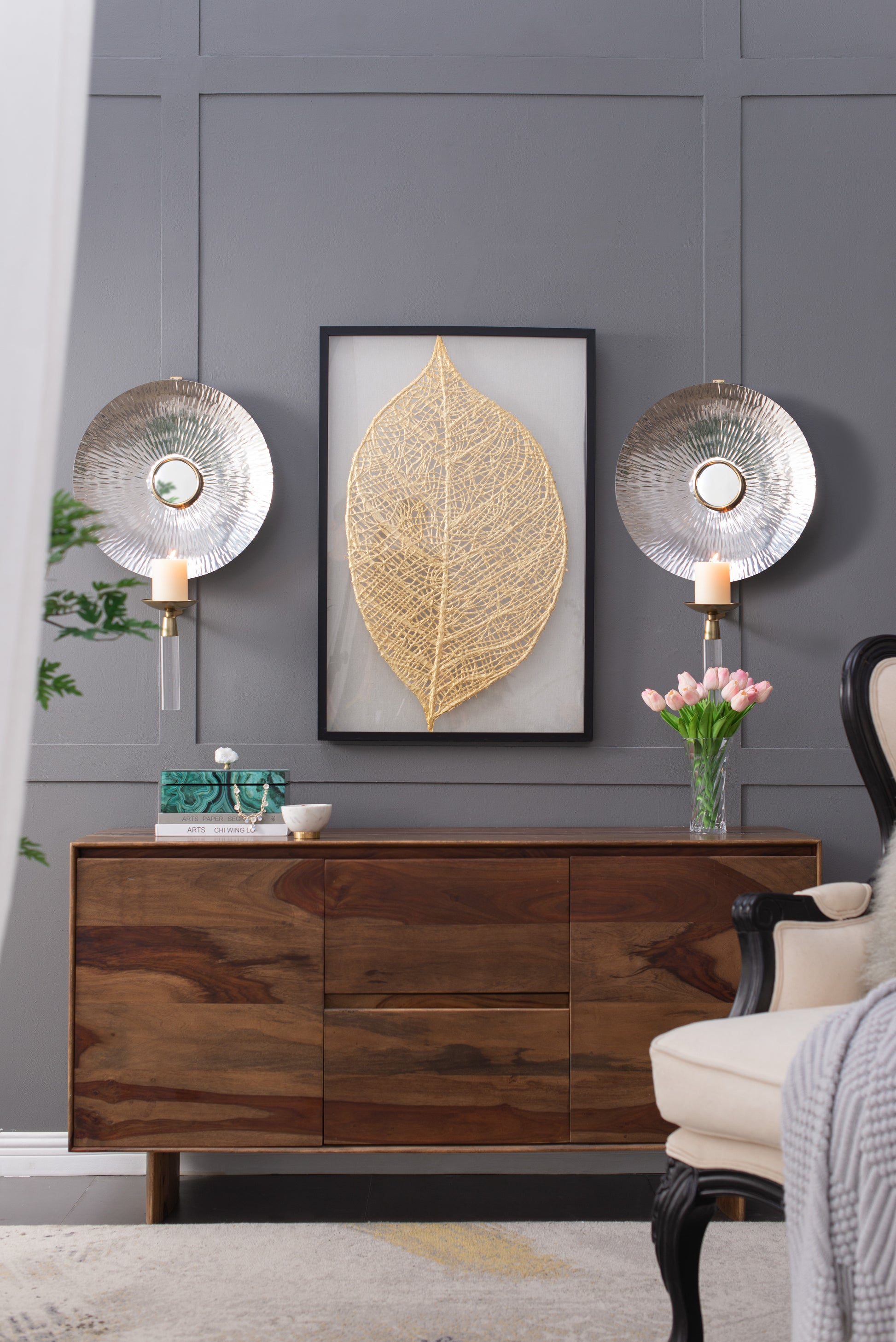 Textured silver wall sconce with candle holder and mirrored accent