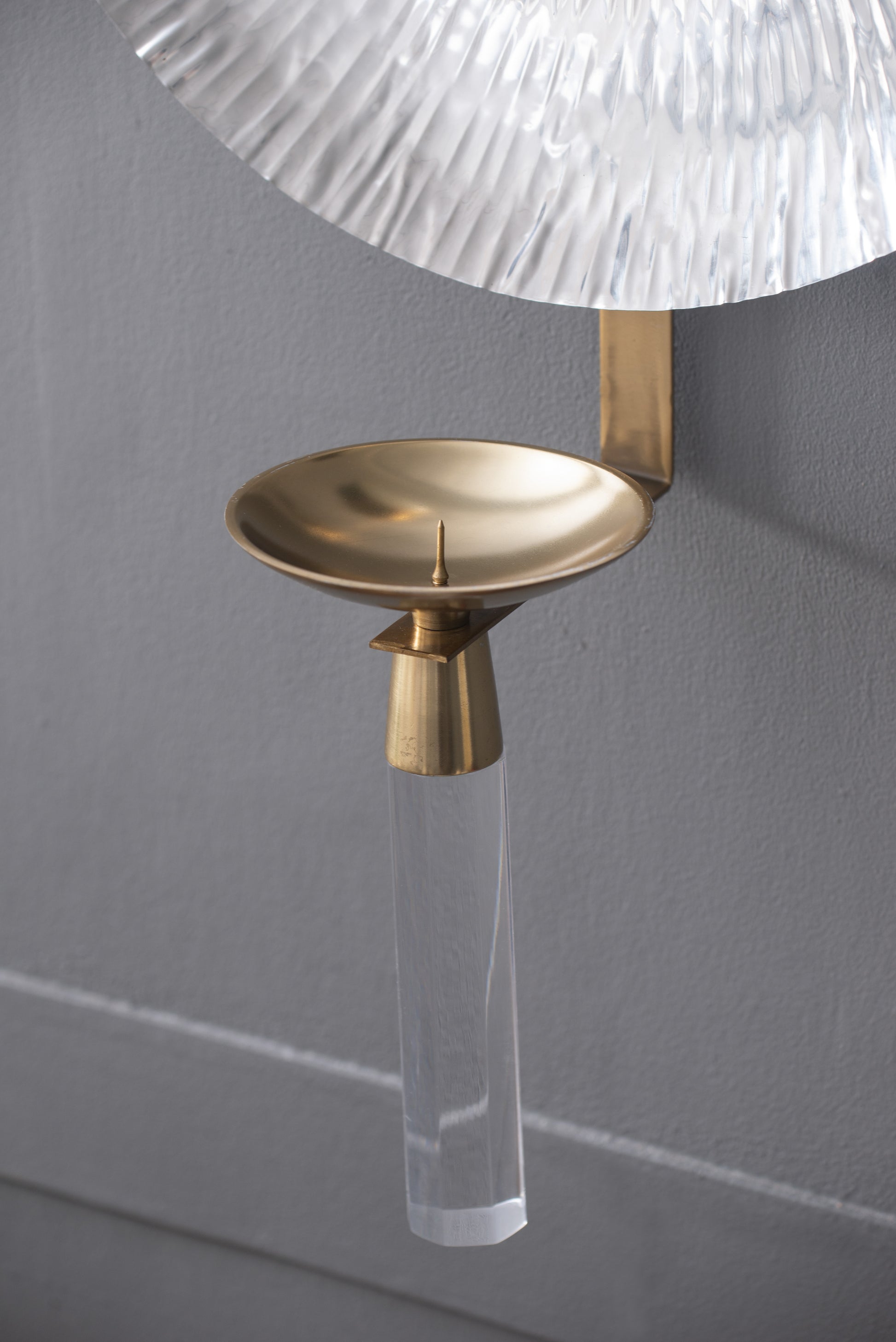 Gold sconce with clear acrylic base and textured glass shade