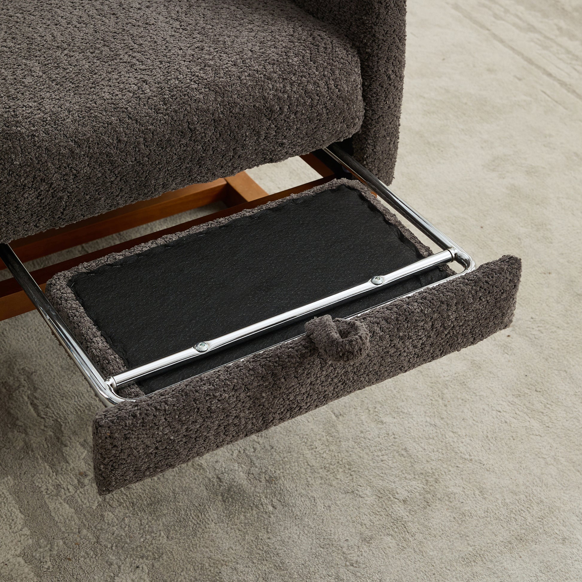 Dark grey plush reclining armchair footrest extension with chrome supports