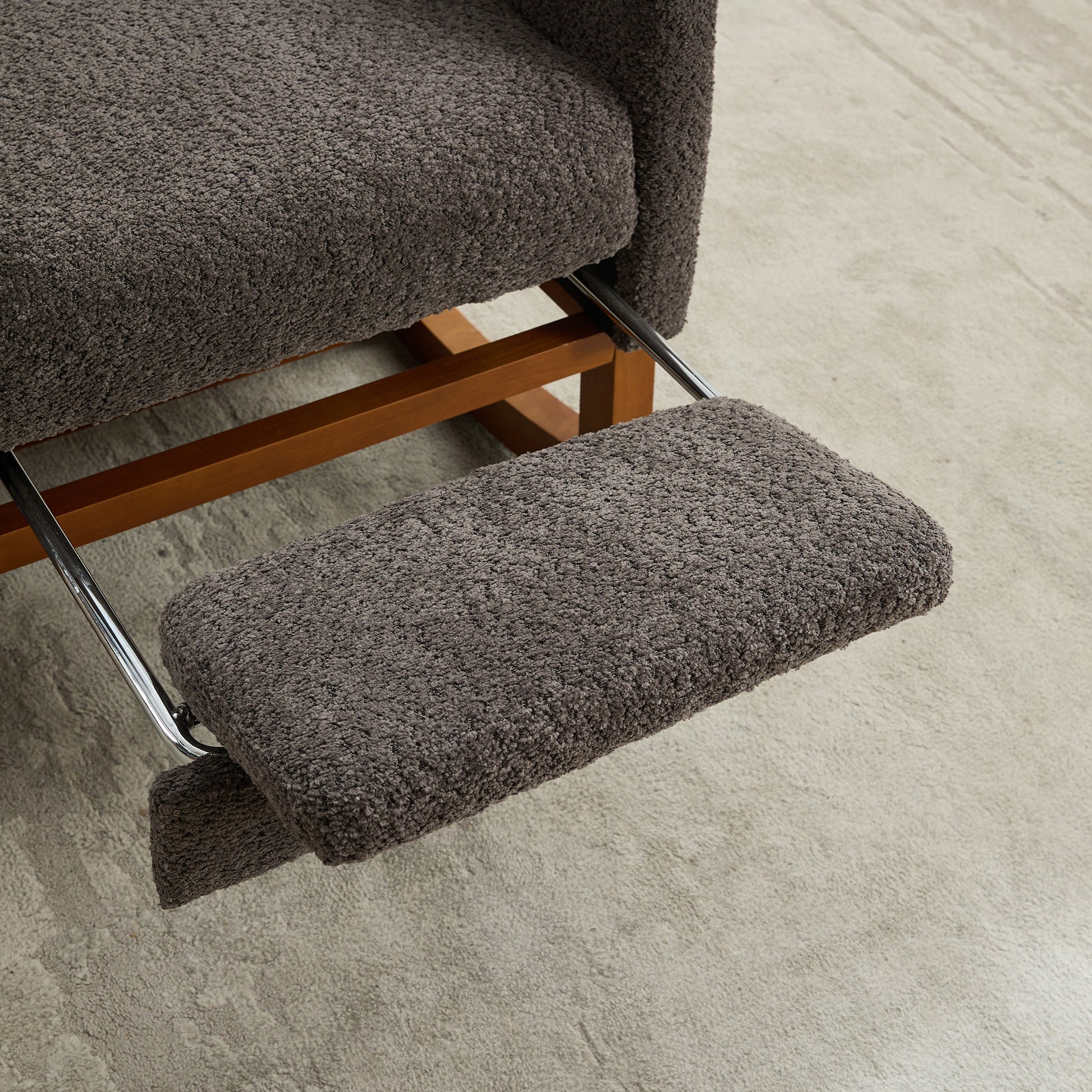 Dark gray textured recliner footrest on wooden frame designed for ultimate comfort