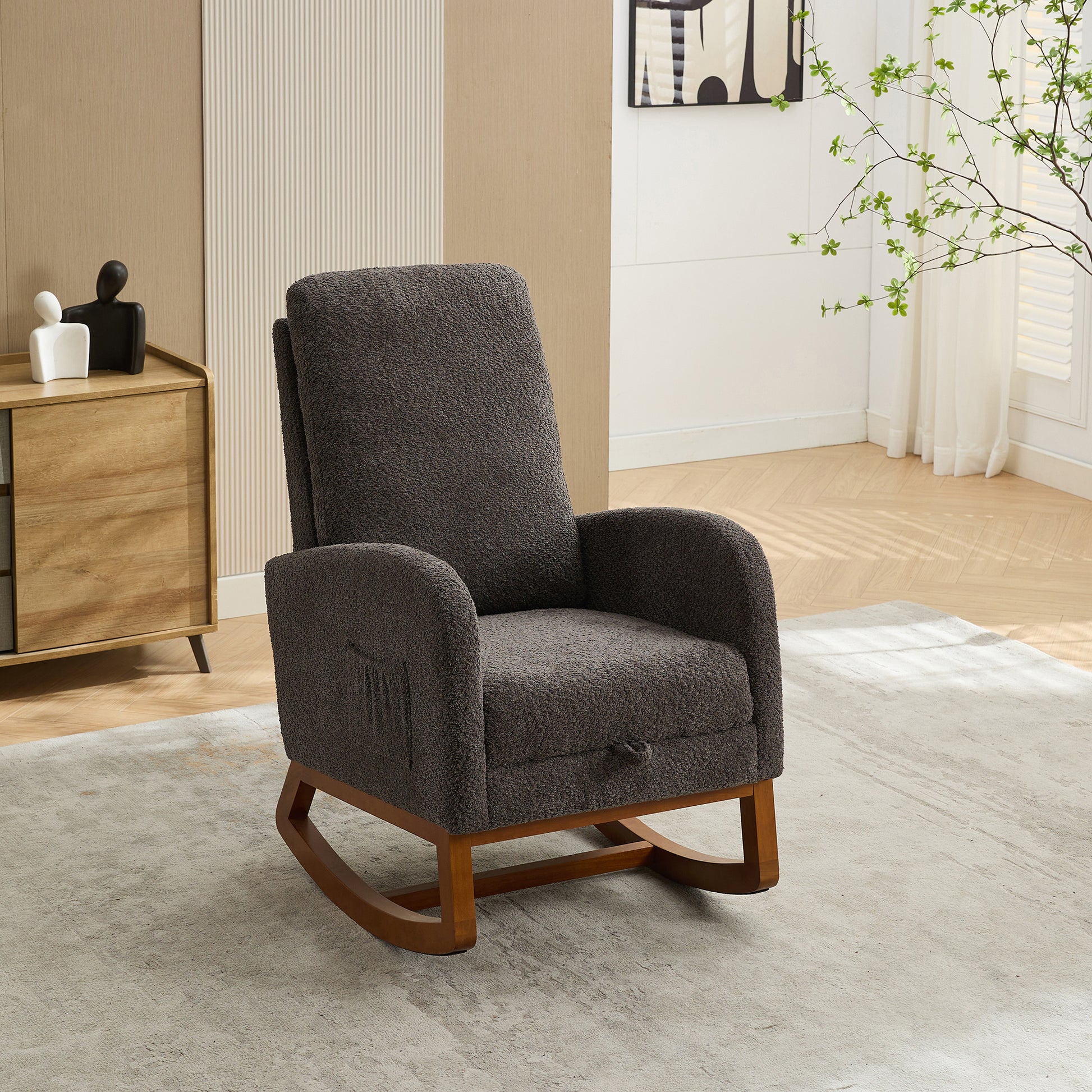 Dark grey plush rocking chair with wooden base and armrest pockets