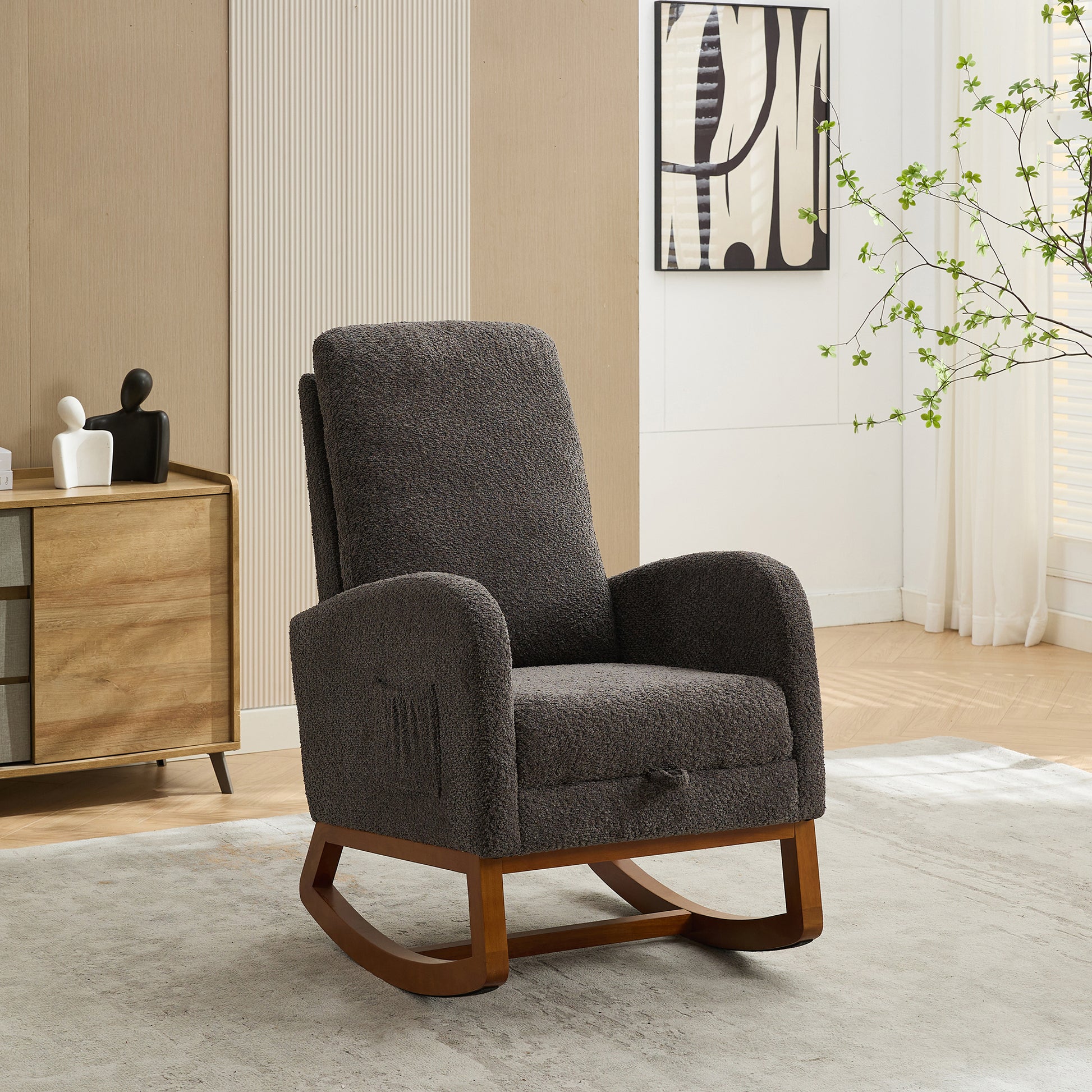 Plush dark gray fabric rocking chair with wooden runners and armrest pockets